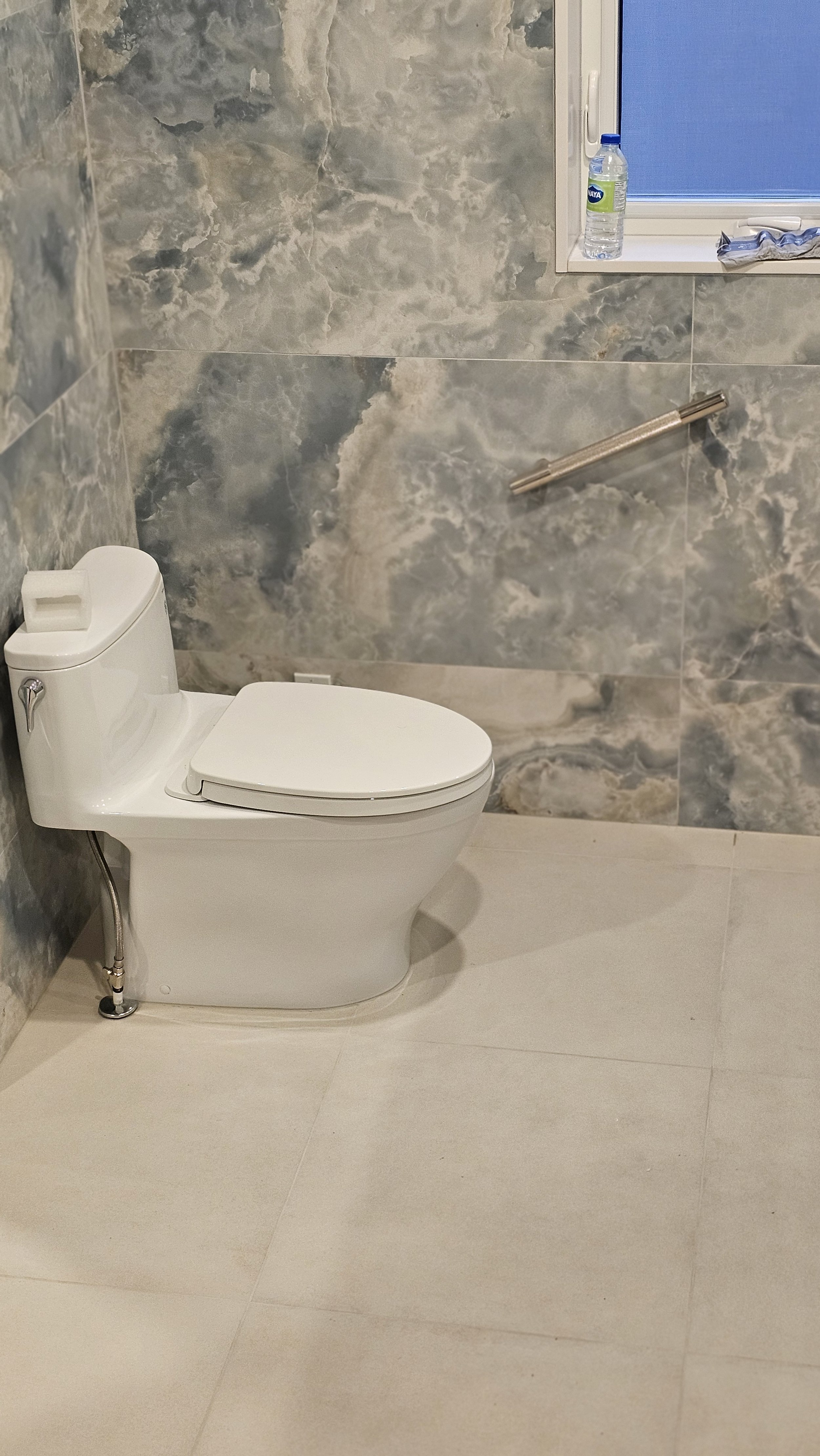 This bathroom renovation combines comfort, style, and accessibility for everyday living. The space features a heated toilet installation, heated tile floors for warmth, and Blue Sky wall tiles for a modern, fresh look. A premium grab bar has been ins