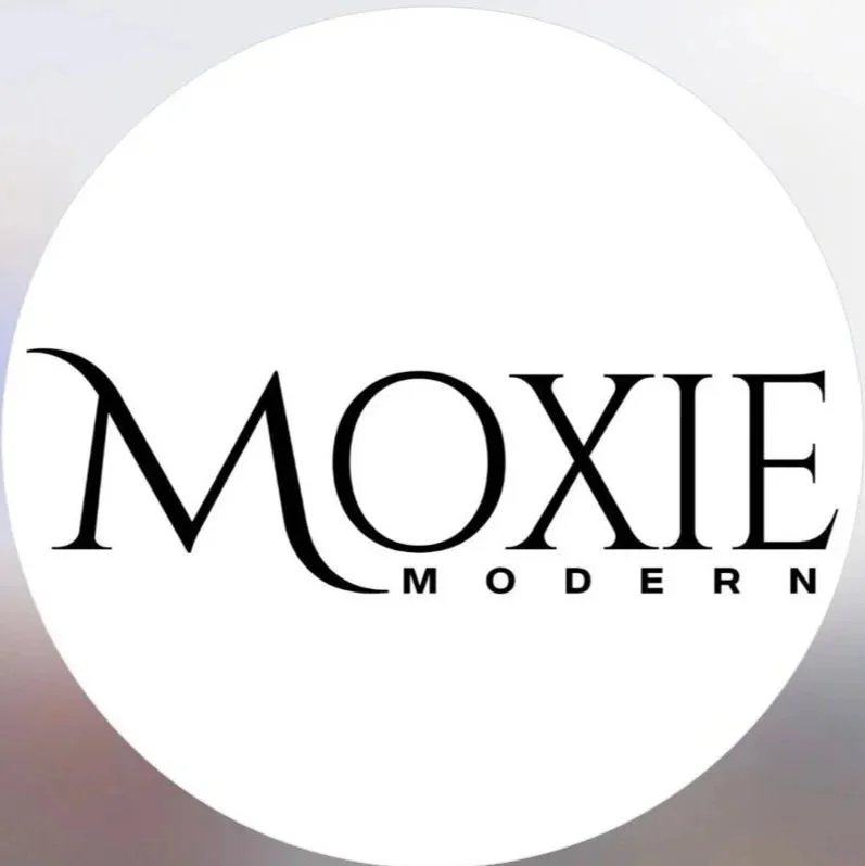 Logo for Moxie Modern with black text on a white circular background
