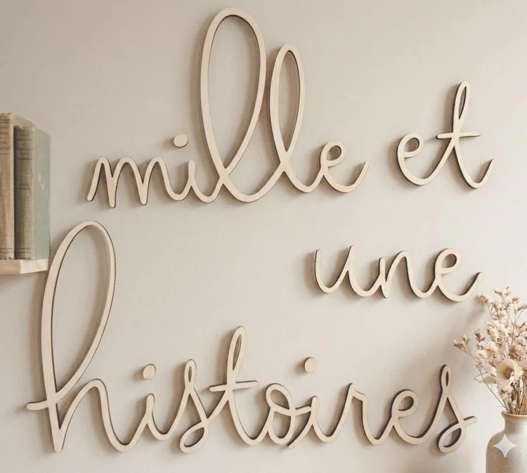 Décoration murale « mille et une histoires » en lettres attachées en bois naturel, près d'une étagère à livres