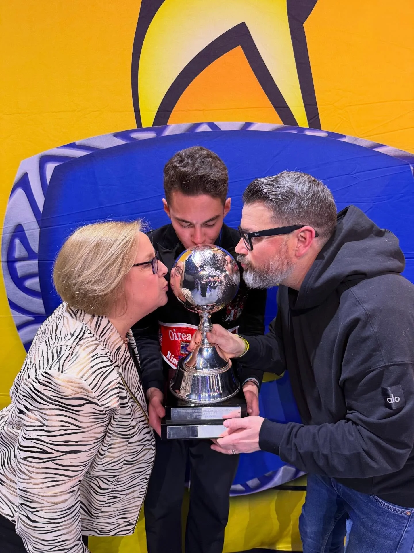 A young man and his teachers holding globe celebrating 3rd place at the World Irish Dancing Championships 2026.