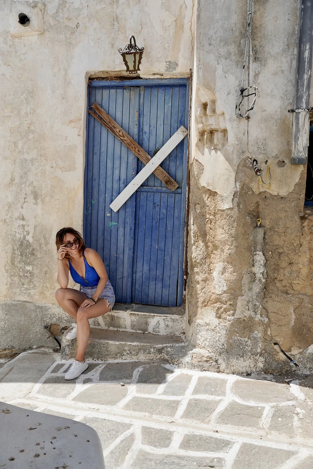 Woman in blue doorway on a Greek island
