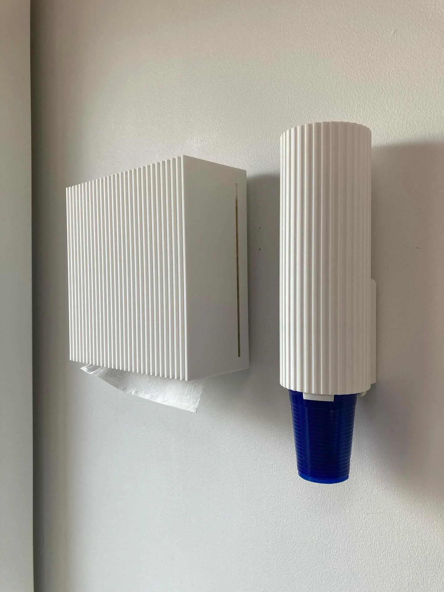 After a few months of refining and in house testing, here is our custom made tork dispenser. We now use it everywhere in the practice. 
I hated the look of most Tork dispensers, ugly shiny boxes, so I made a new one. 

Entirely printable on most FDM 