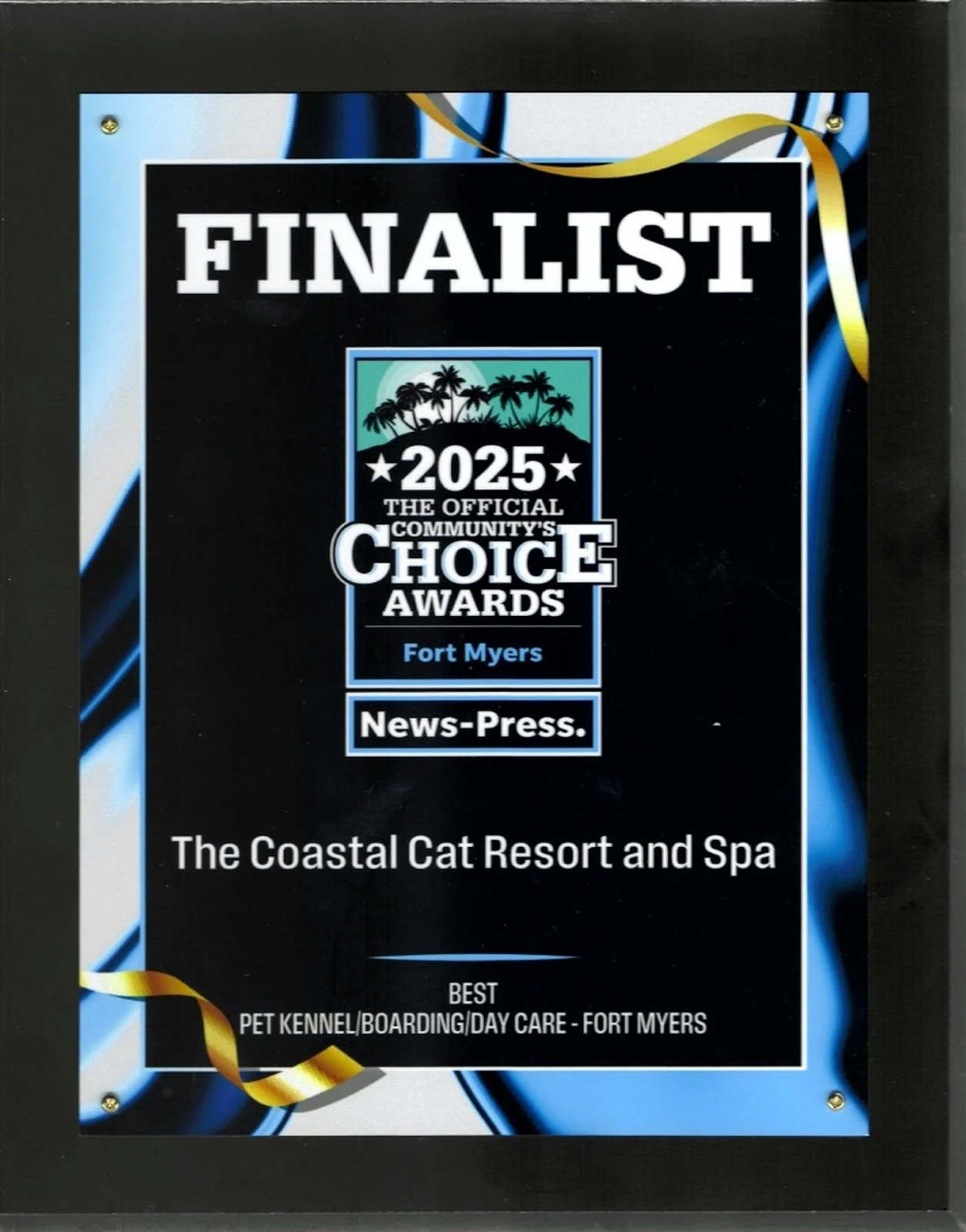 A plaque recognizing the finalist of the 2025 Community Choice Awards in Fort Myers, awarded by News-Press for the best pet kennel, boarding, or day care, with a tropical palm tree graphic at the top.