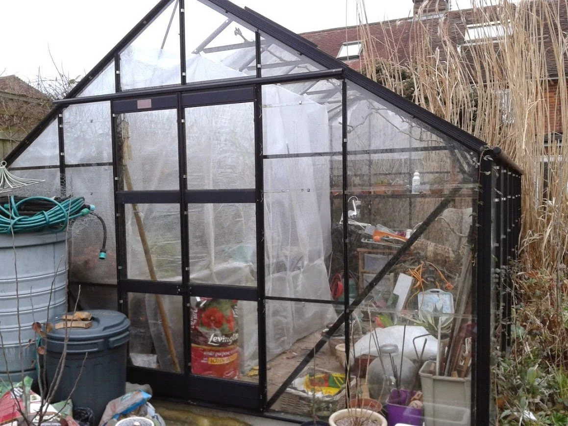 a greenhouse with a walled off section of insulation