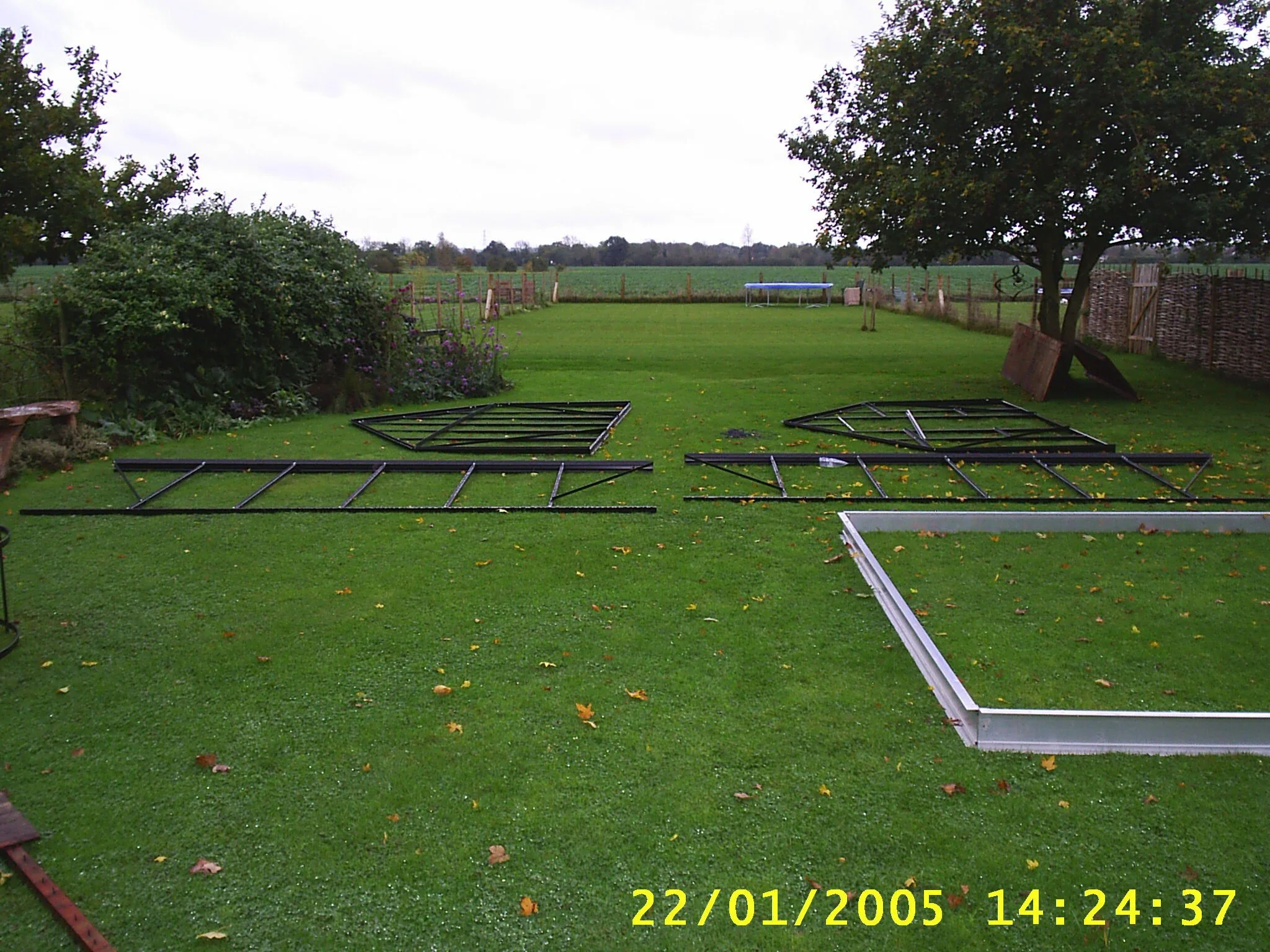 greenhouse panels laid out on a lawn
