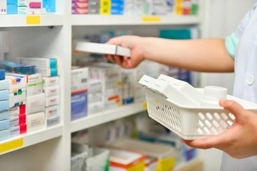 Pharmacist filling a prescription at MiraMedx Pharmacy in Shelby Township, MI