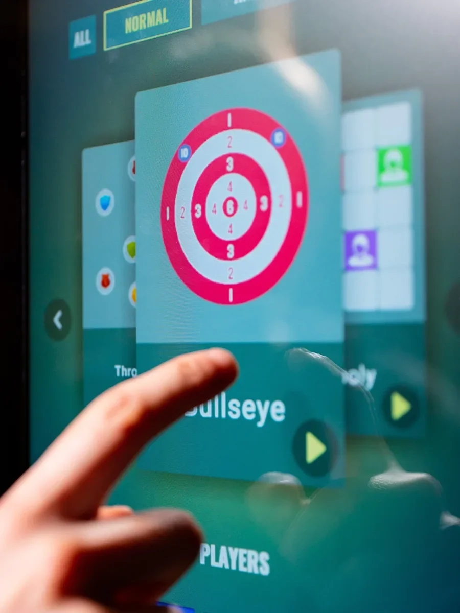 A finger touching an interactive scoring screen