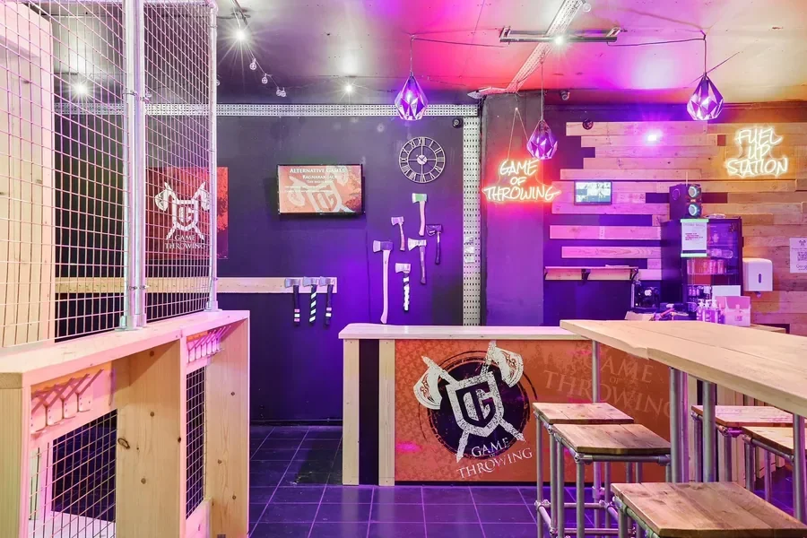 Interior of the axe-throwing arena with neon signage
