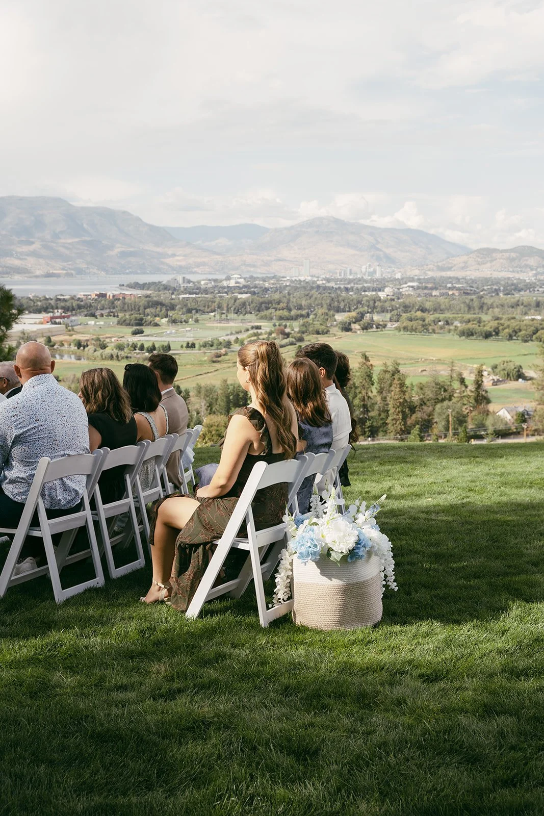 Guests watching the ceremony from their seats on the lawn