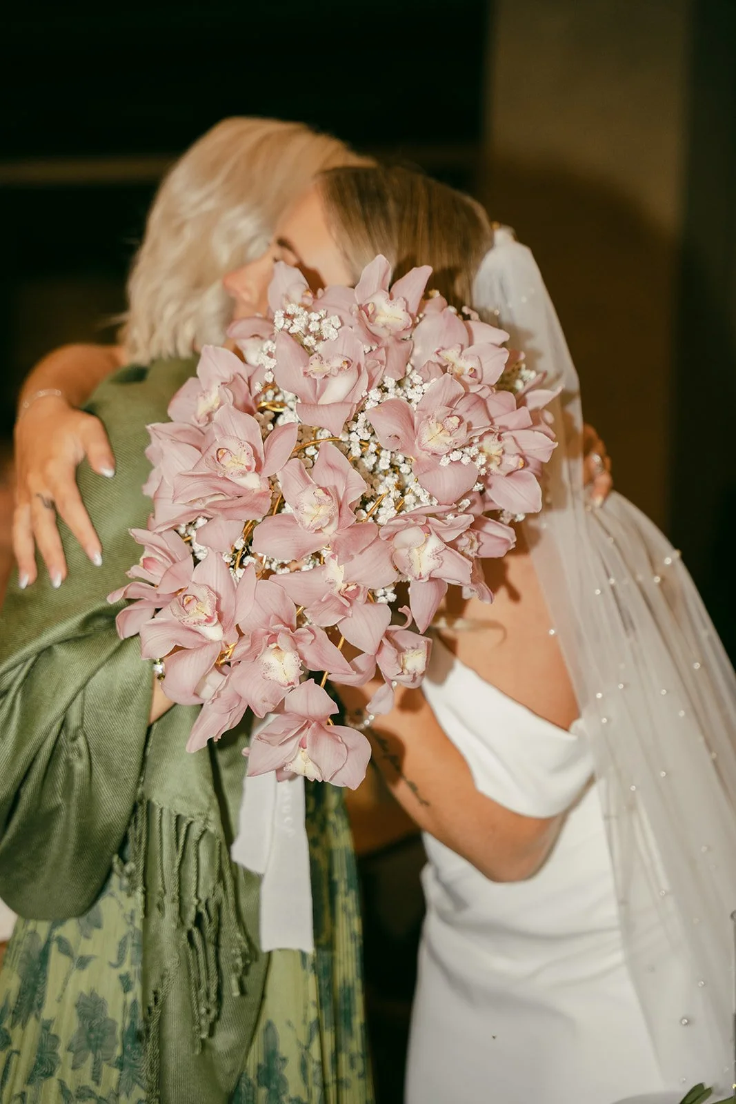 Bride holding a replica of her mom's wedding bouquet