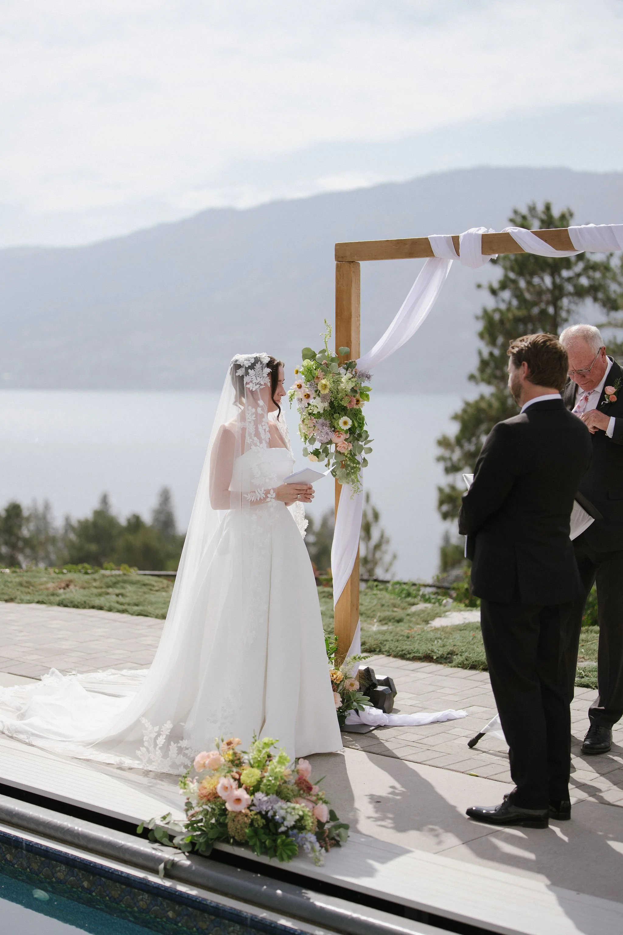 Cat & Cam exchanging vows overlooking the lake