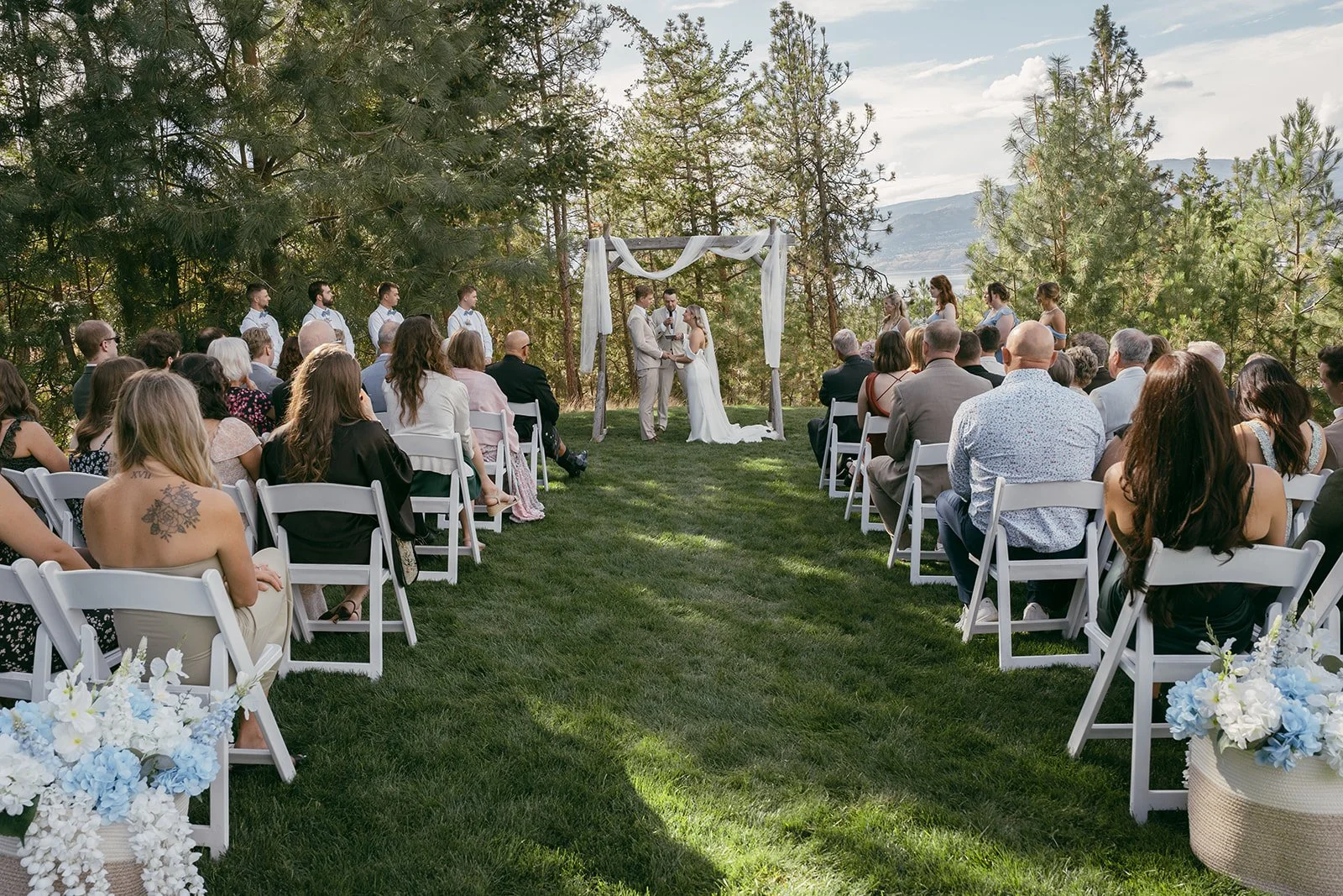 Ceremony space styled with soft florals and blue accents