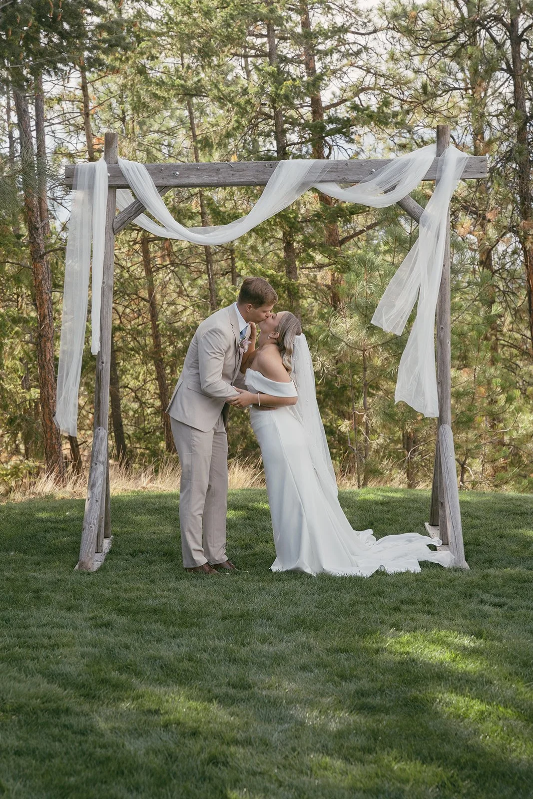 Couple sharing their first kiss as newlyweds