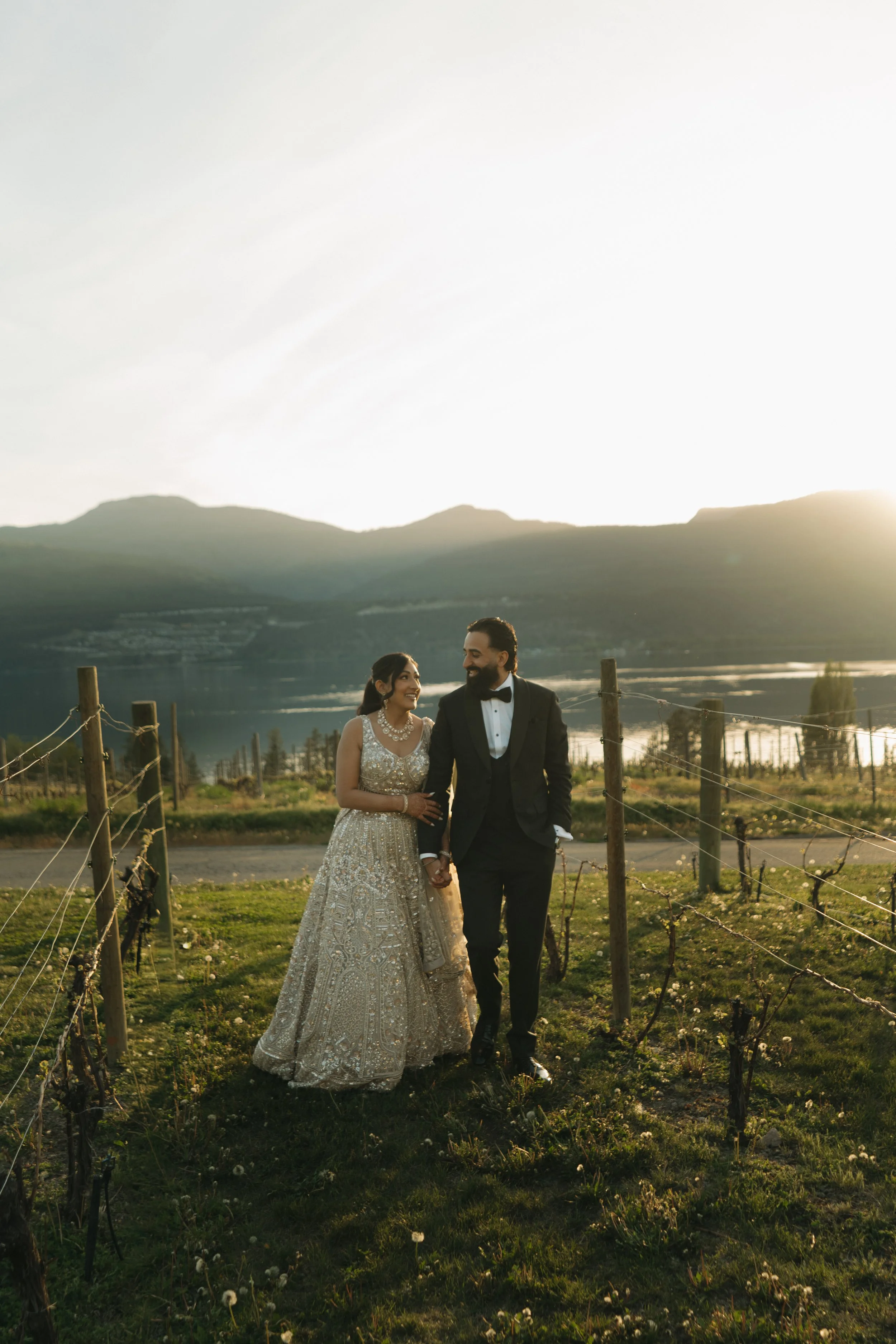Newlyweds enjoying portraits among the vineyards at 50th Parallel Estate Winery