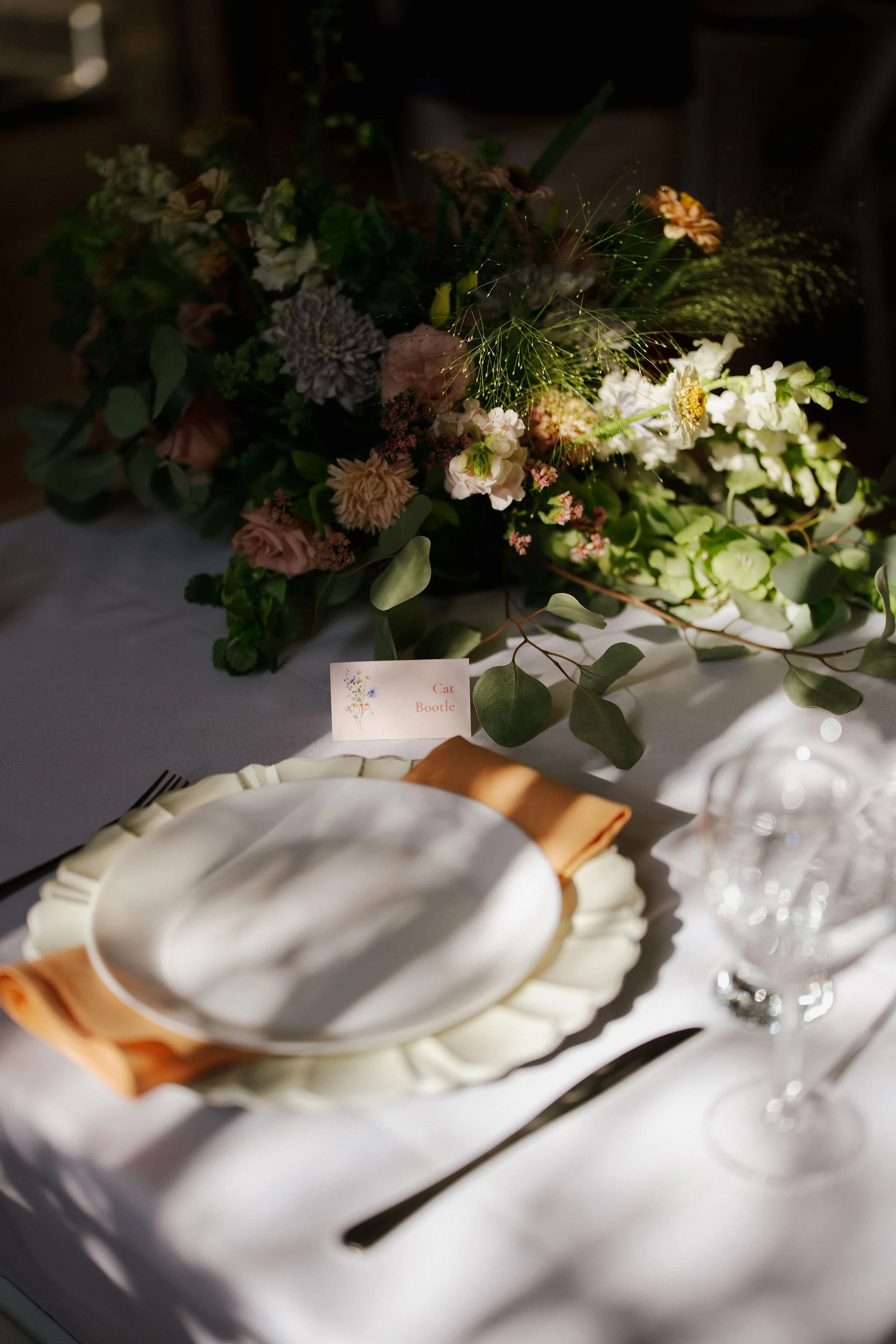 Wedding reception tables decorated with colourful floral arrangements