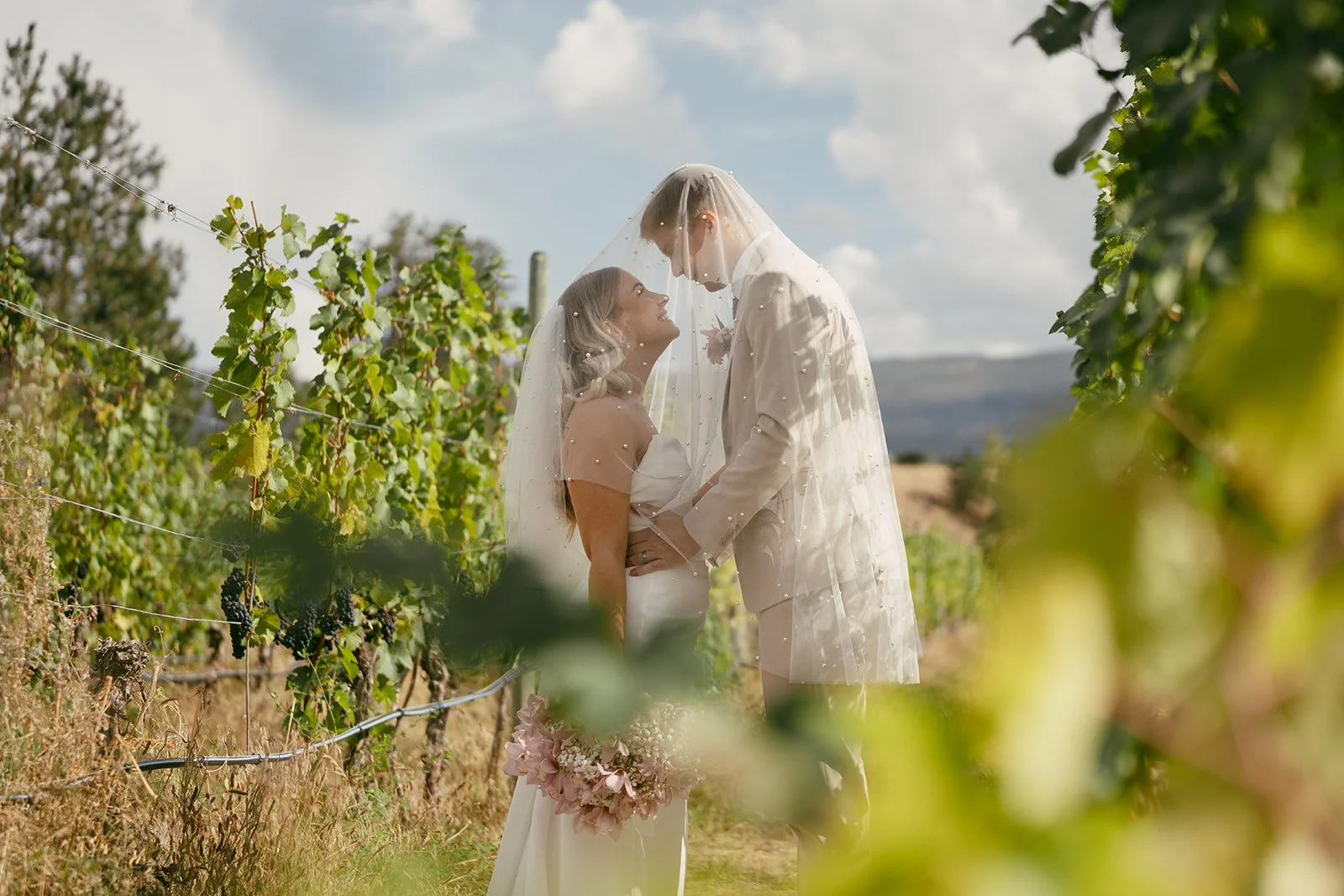 Grace & Freddie sharing a private moment in the Okanagan vineyard