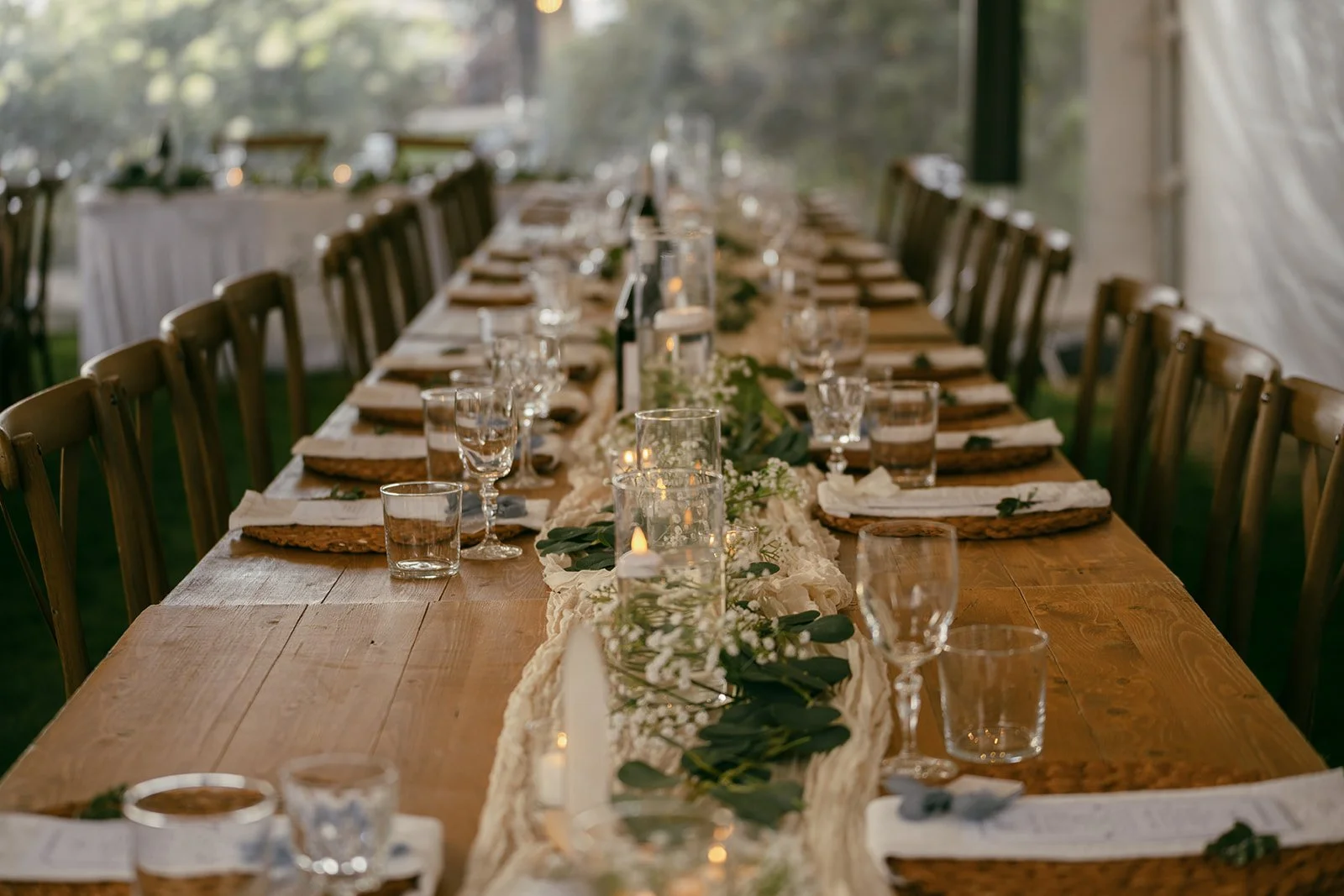Reception tables styled with candles and eucalyptus