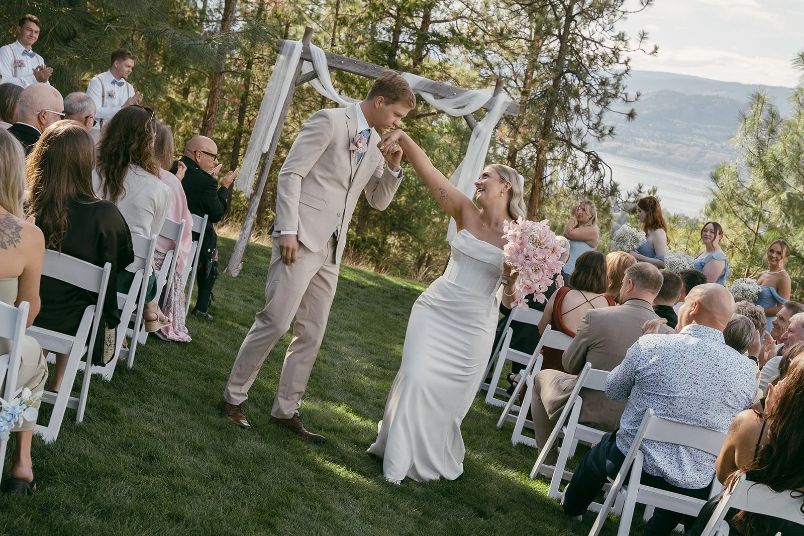 Newlyweds walking down the aisle for their Kelonwa wedding