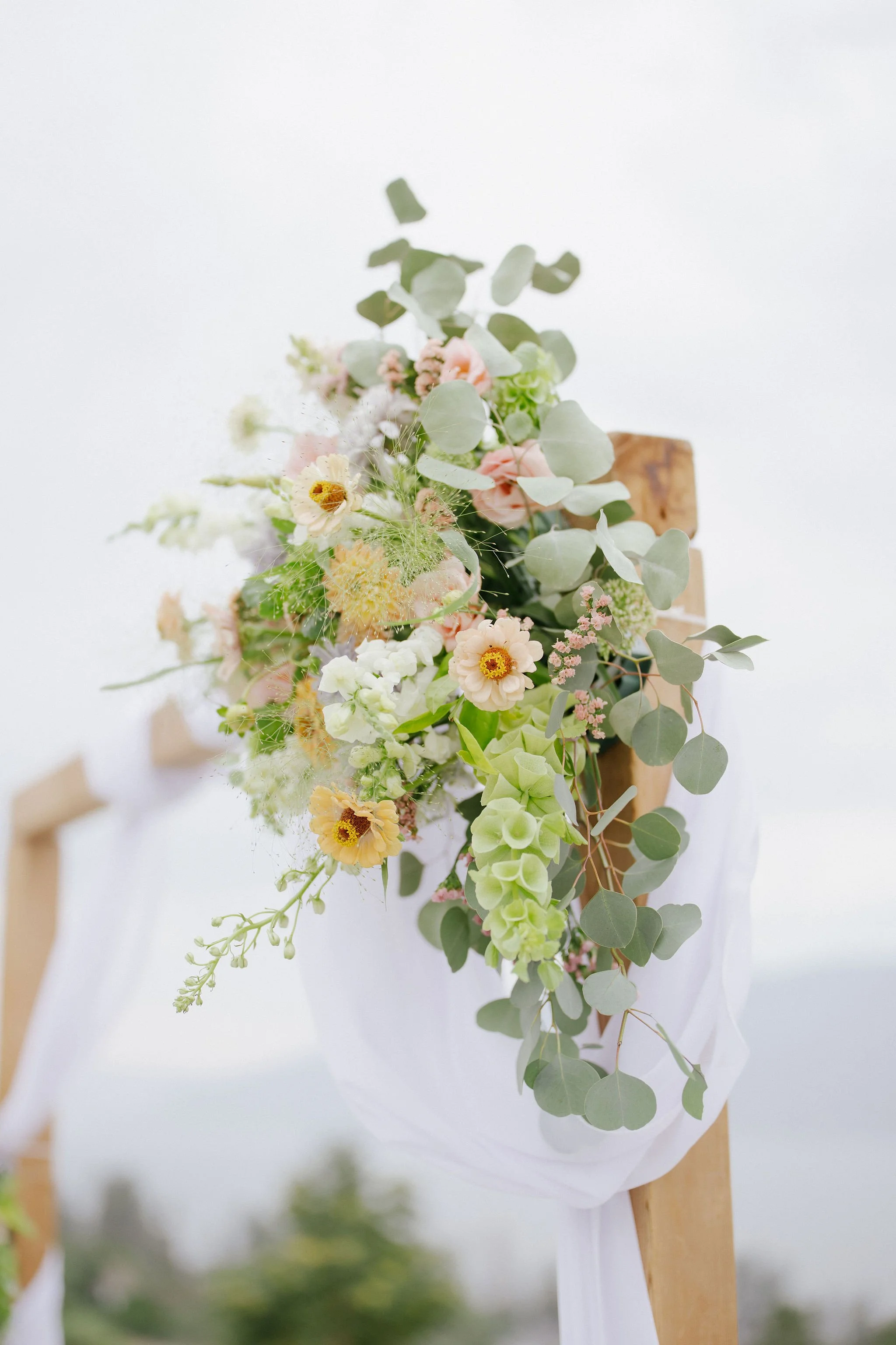 Lush floral arrangements decorating the lakeside wedding