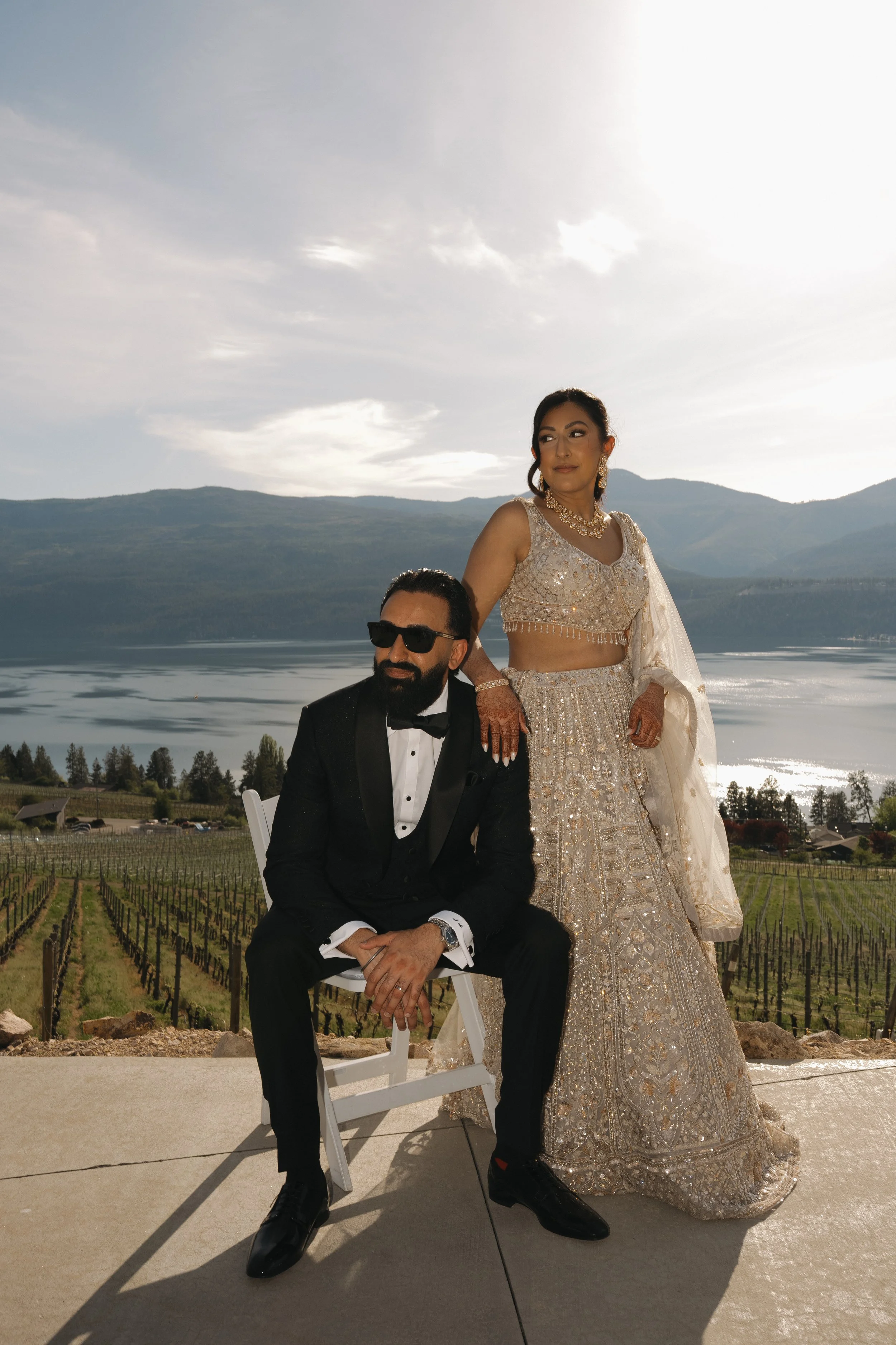Reena & Nov standing together with views of the Okanagan landscape