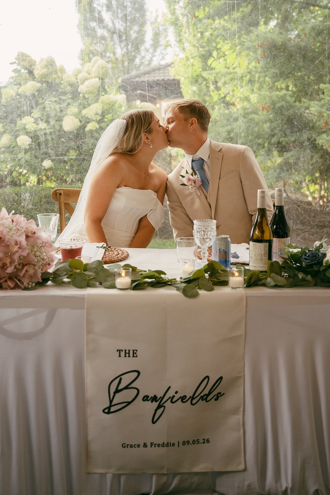 The Banfields newlywed custom banner at the head table