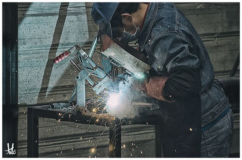 Using a welding jig to weld enclosure sockets onto the frames.