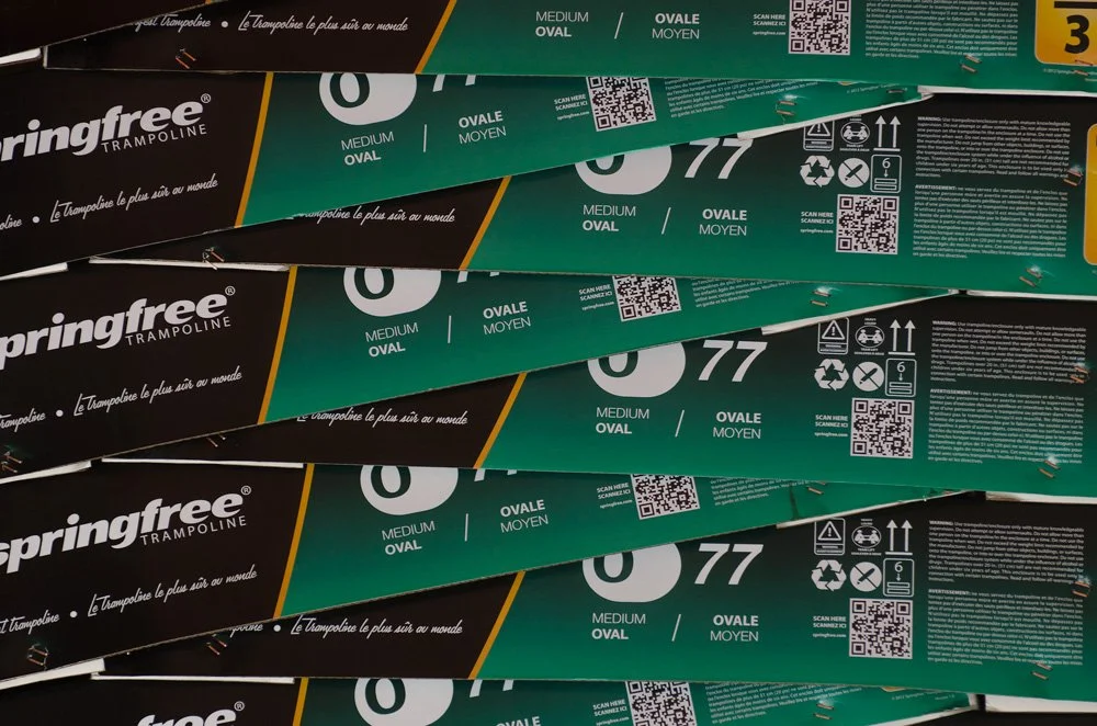 Springfree Trampoline O77 Medium Oval packaging lids.