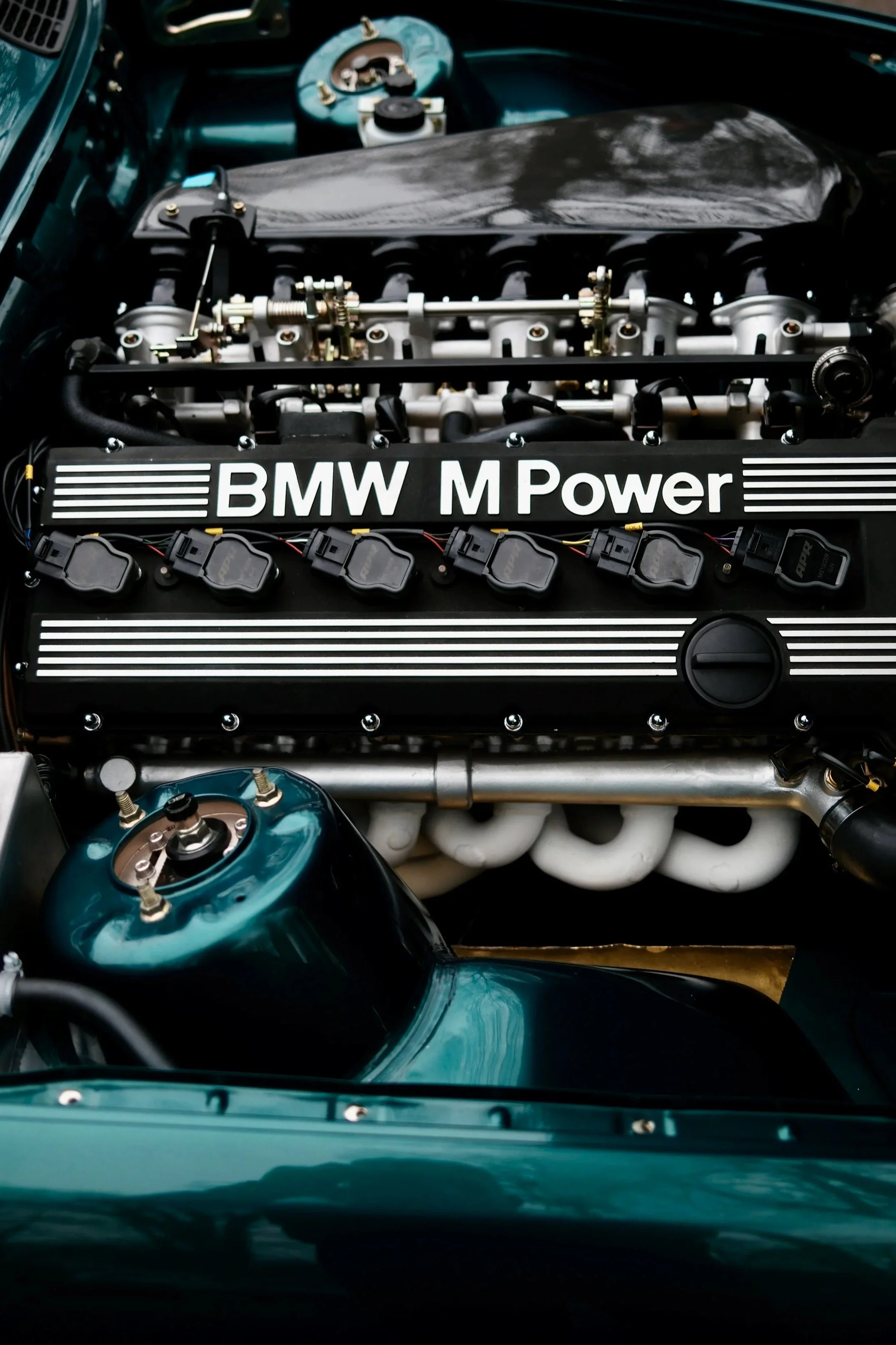 Close-up of a Formula 1 car engine with visible components, branding, and intricate mechanical details.