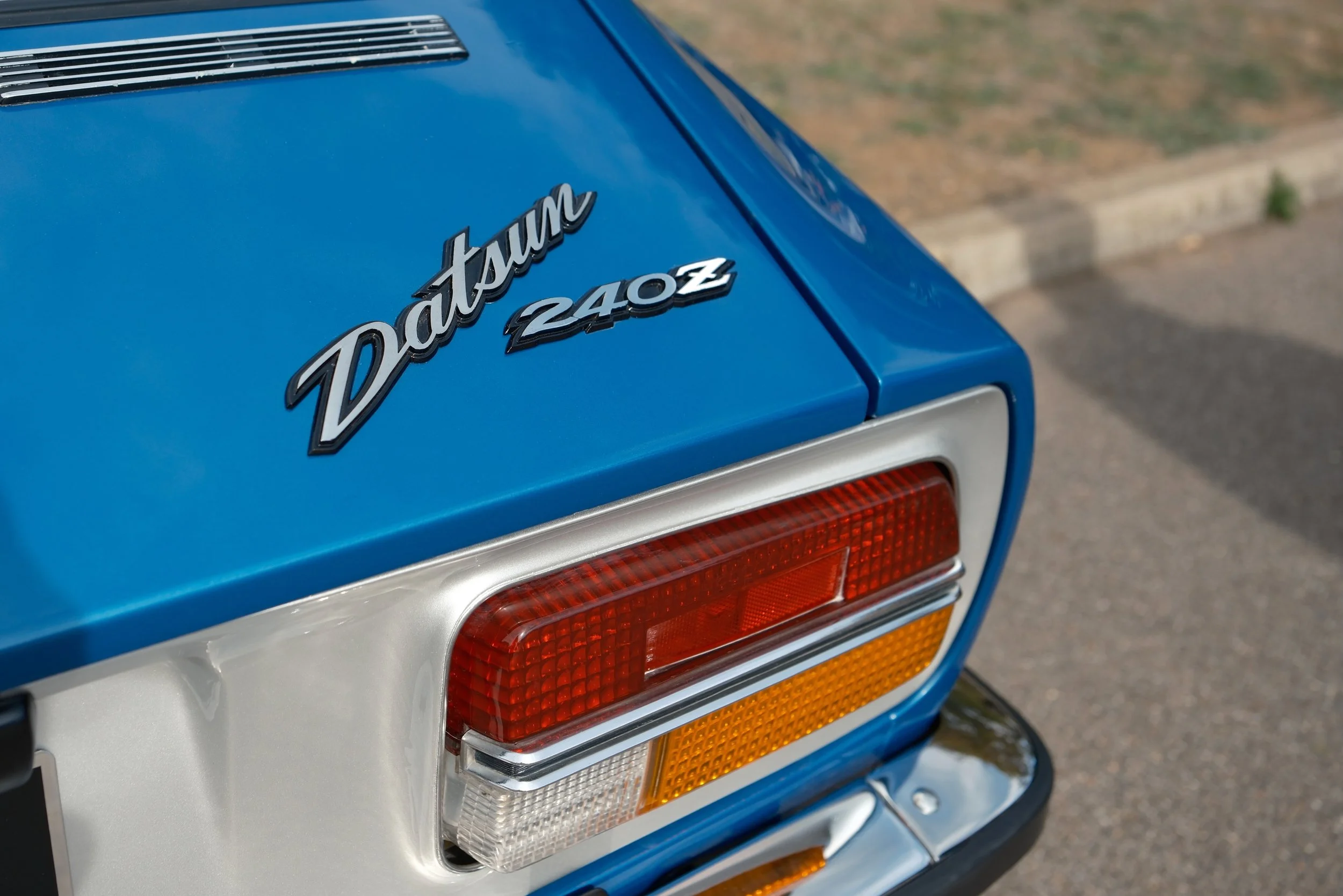 Close-up of the rear end of a vintage blue Porsche 924 with model badge.