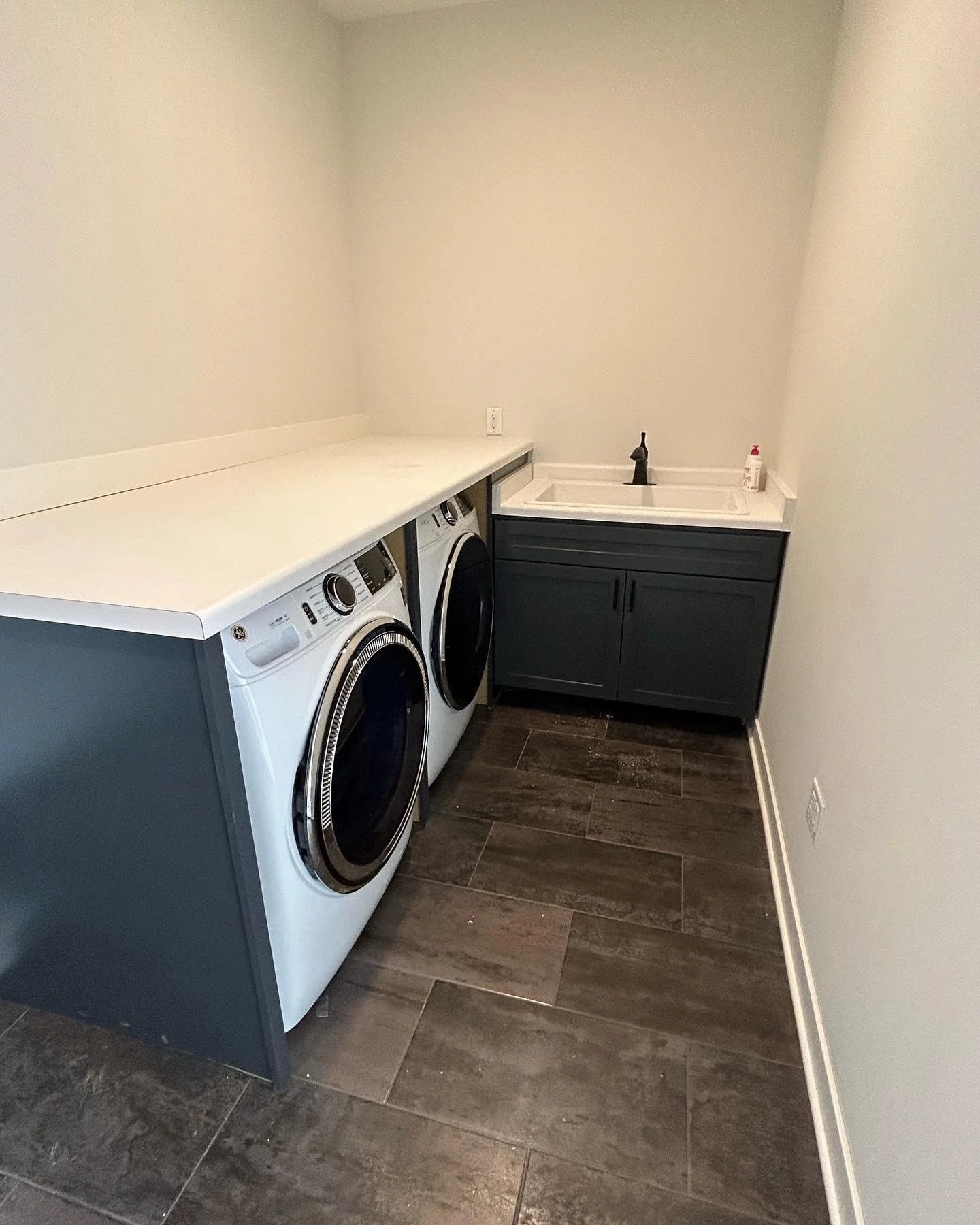 Laundry room folding space with dog-wash sink.