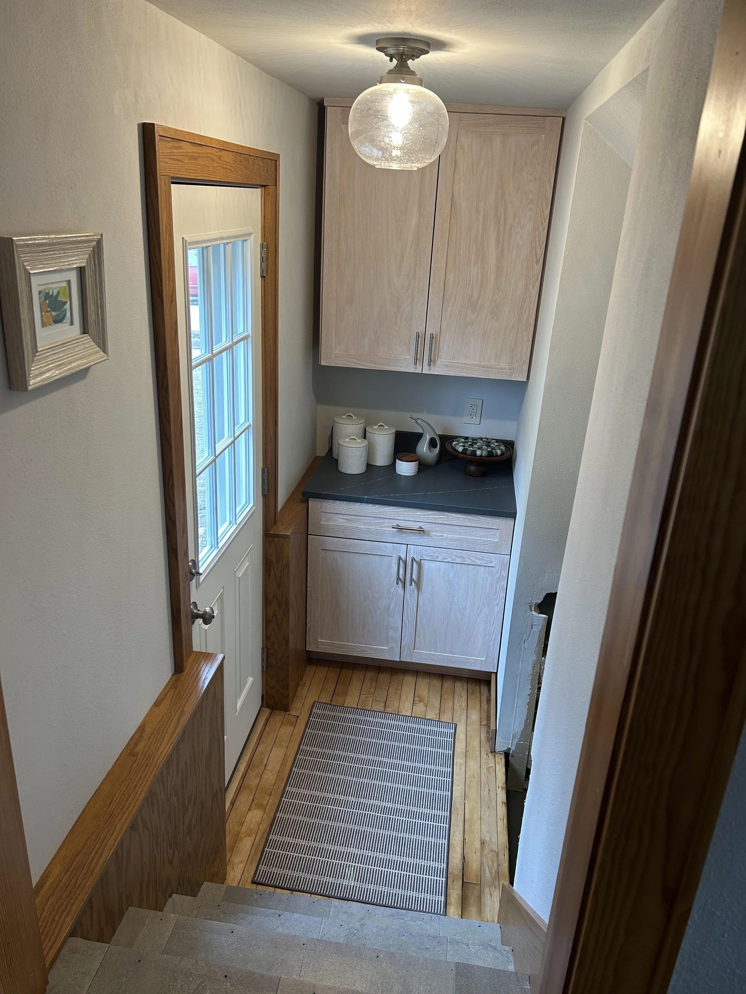 Turned this previously unused space into a pantry and refinished maple hardwood floors. 
