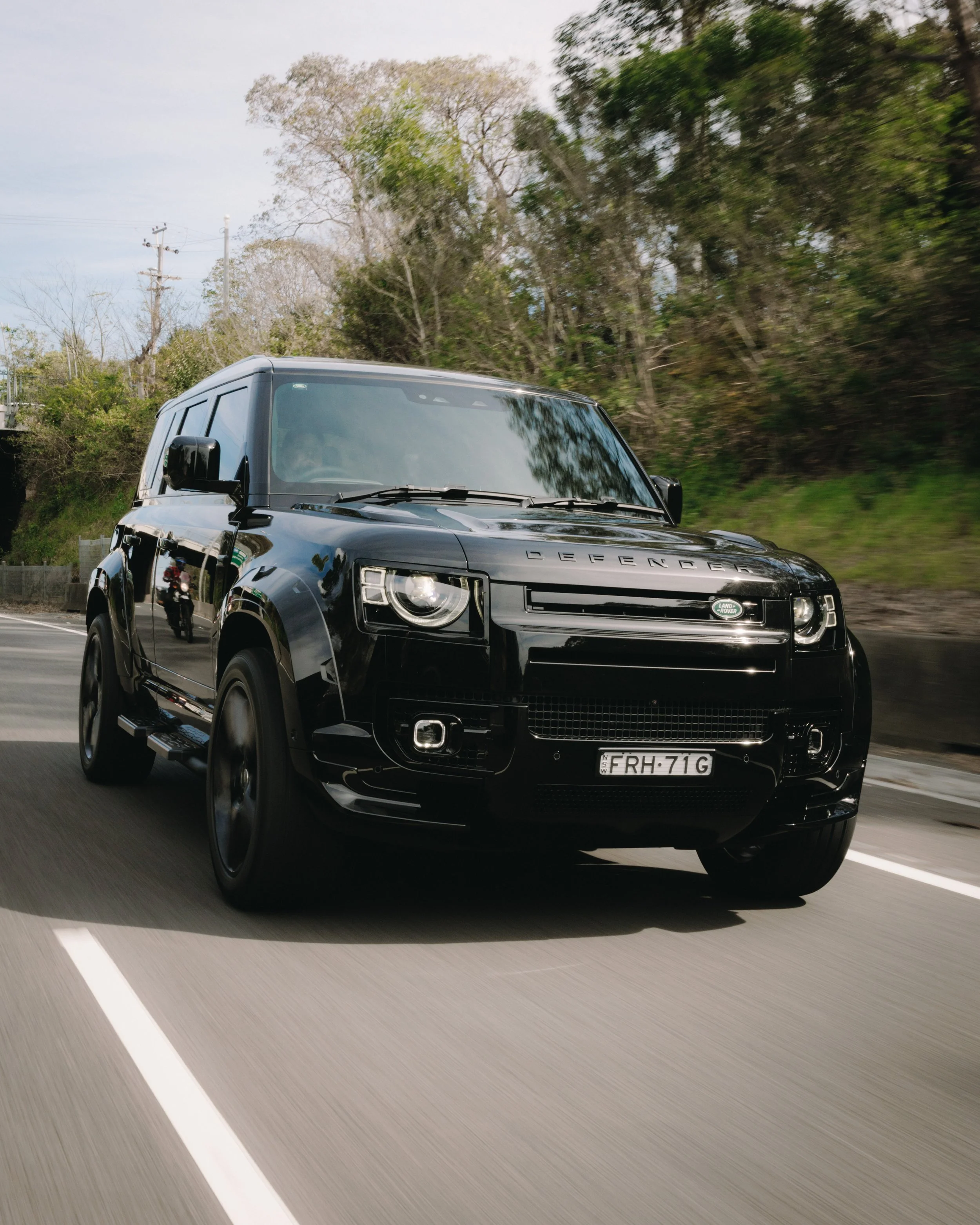 Black Land Rover Defender fitted with an Urban Automotive widebody kit and gold brake calipers painted by Koguma Garage, specialists in luxury 4x4 customisation, body kits, and performance styling in Wollongong.