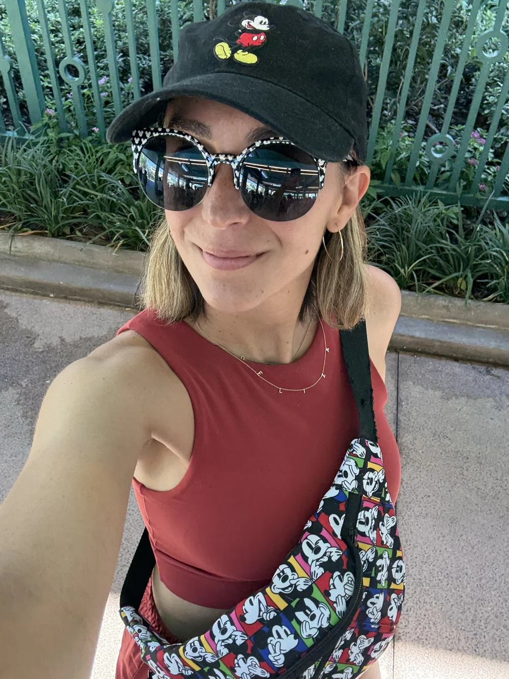 Red Aerie Offline set and black classic Mickey Mouse outfit with Mickey sunglasses and a Mickey and Friends shoulder bag fanny pack