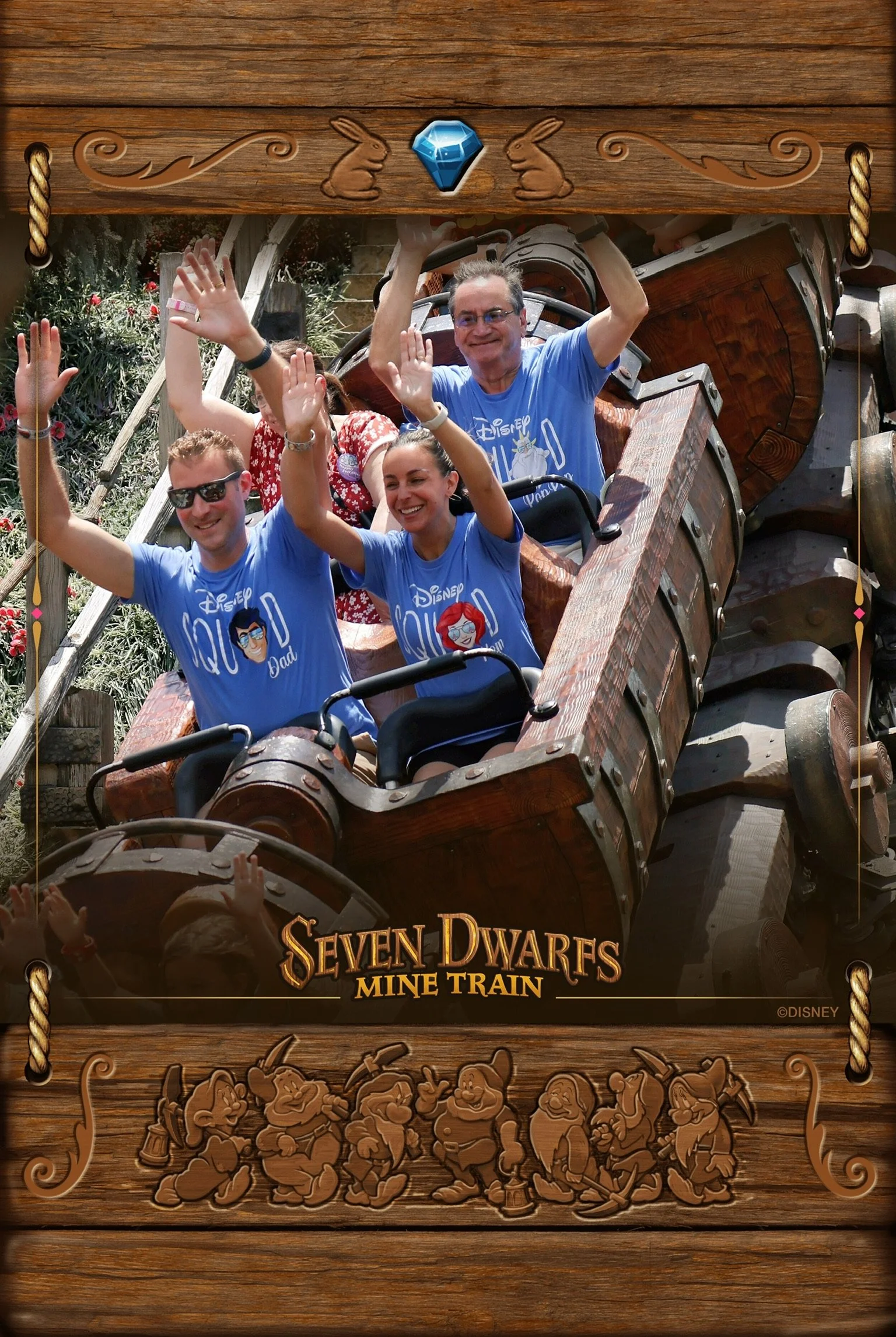 Family having fun on the mine train ride smiling and enjoying themselves