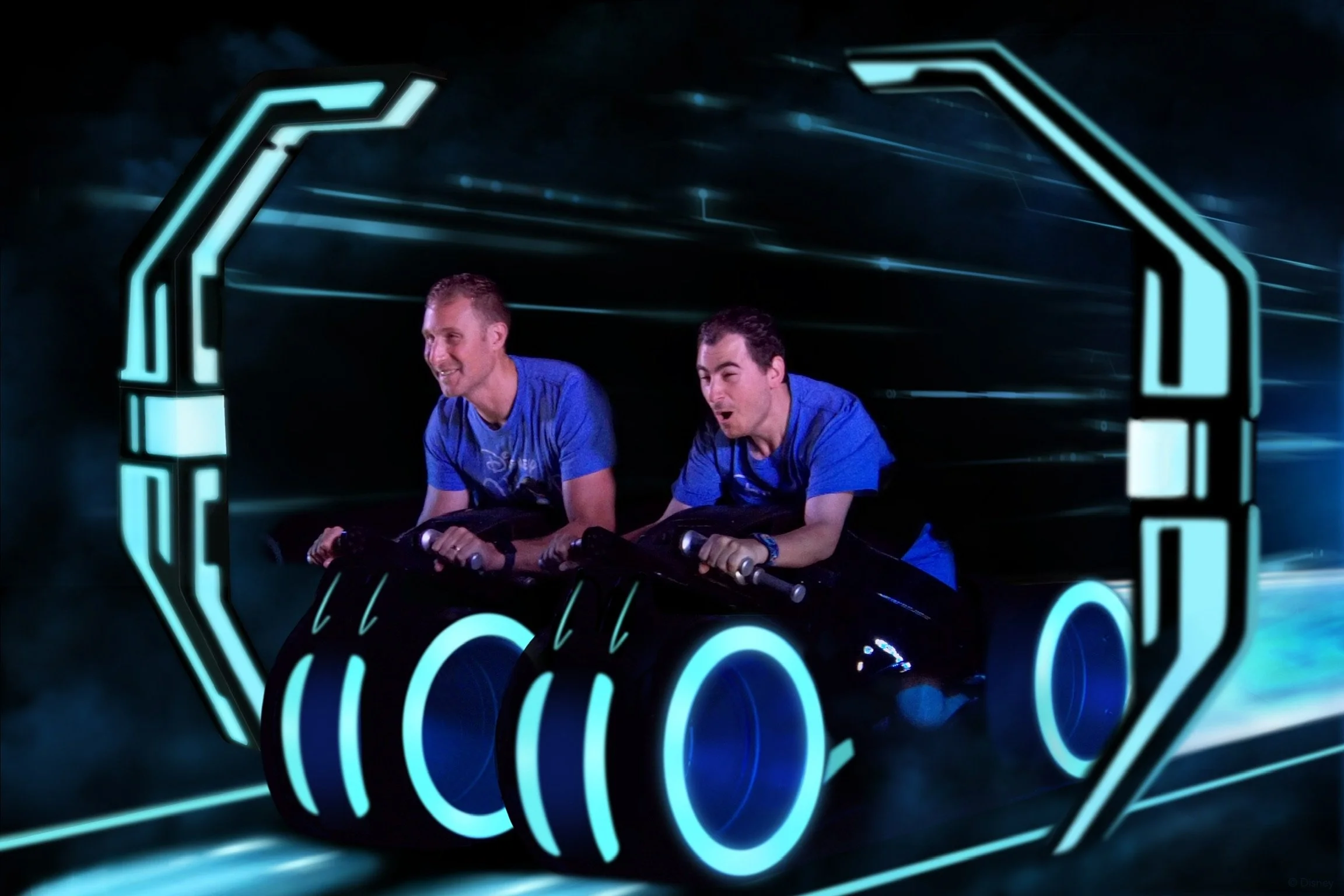 2 men riding Tron at Disney's Magical Kingdom having so much fun
