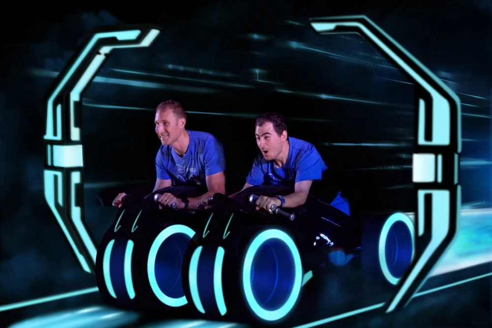 2 men riding Tron at Disney's Magical Kingdom having so much fun