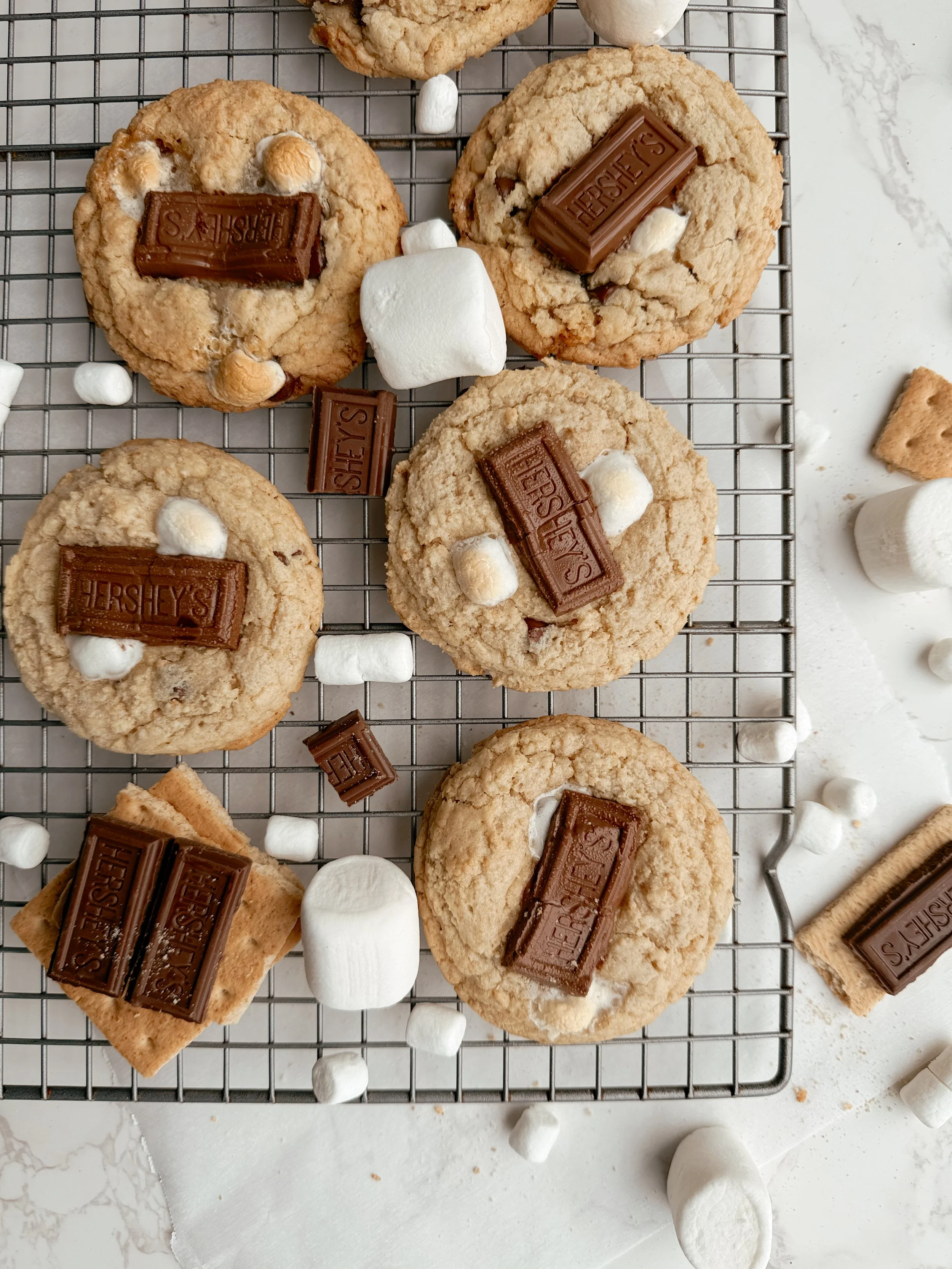 Freshly baked smores cookies cooling on a wire rack