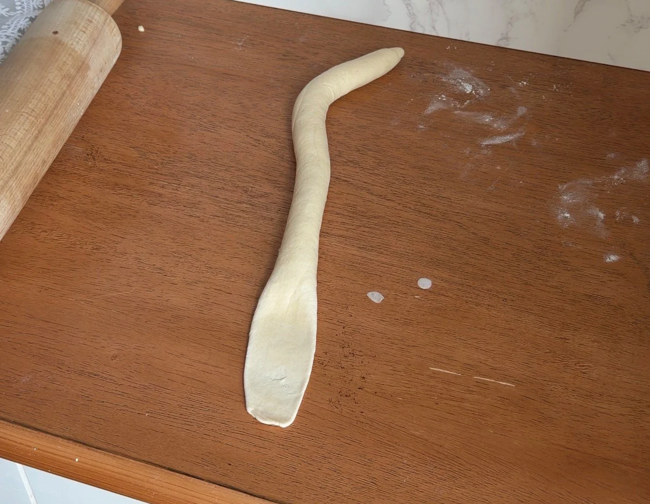 bagel dough on the counter, rolled into rope