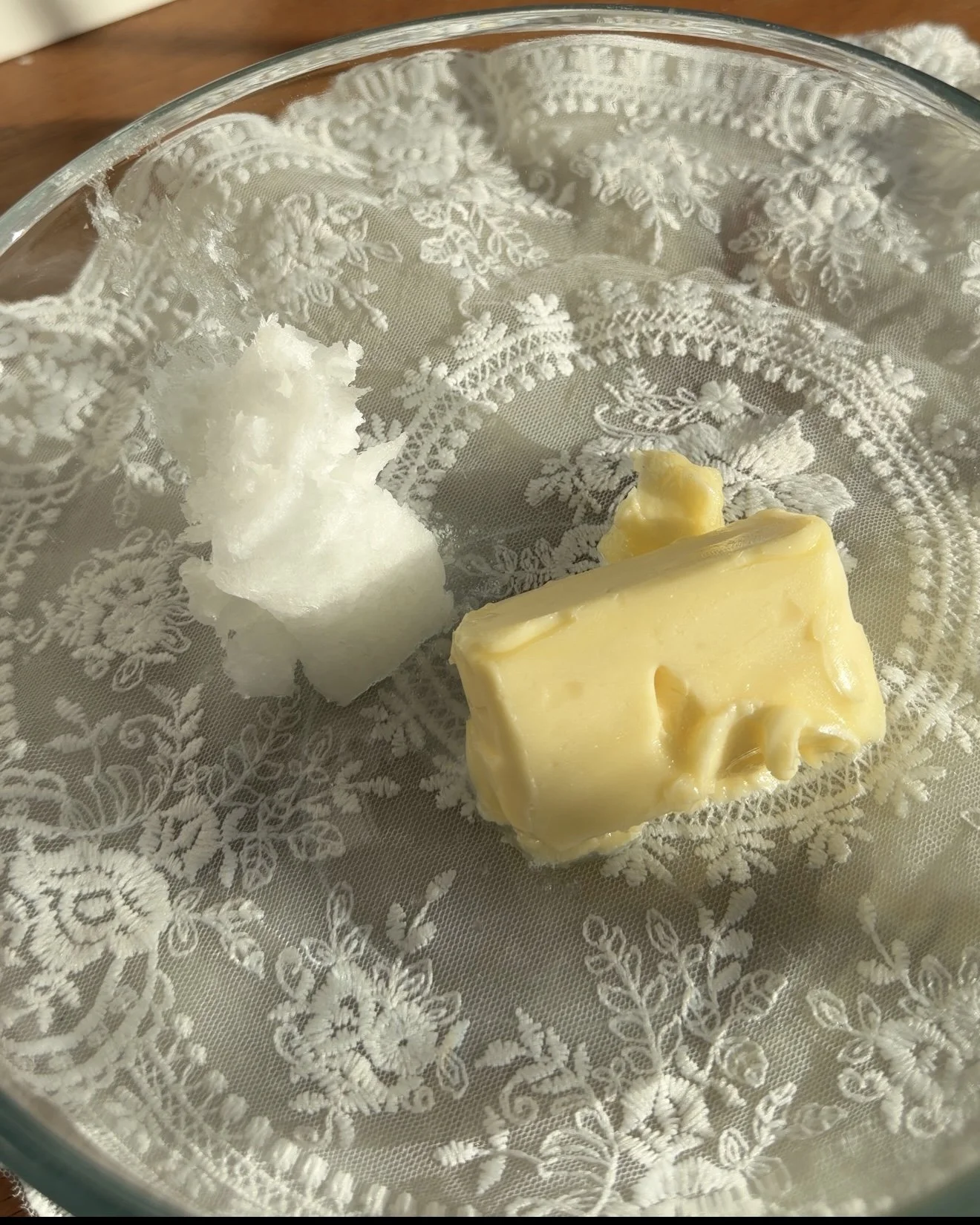 Butter and coconut oil in a mixing bowl on the counter