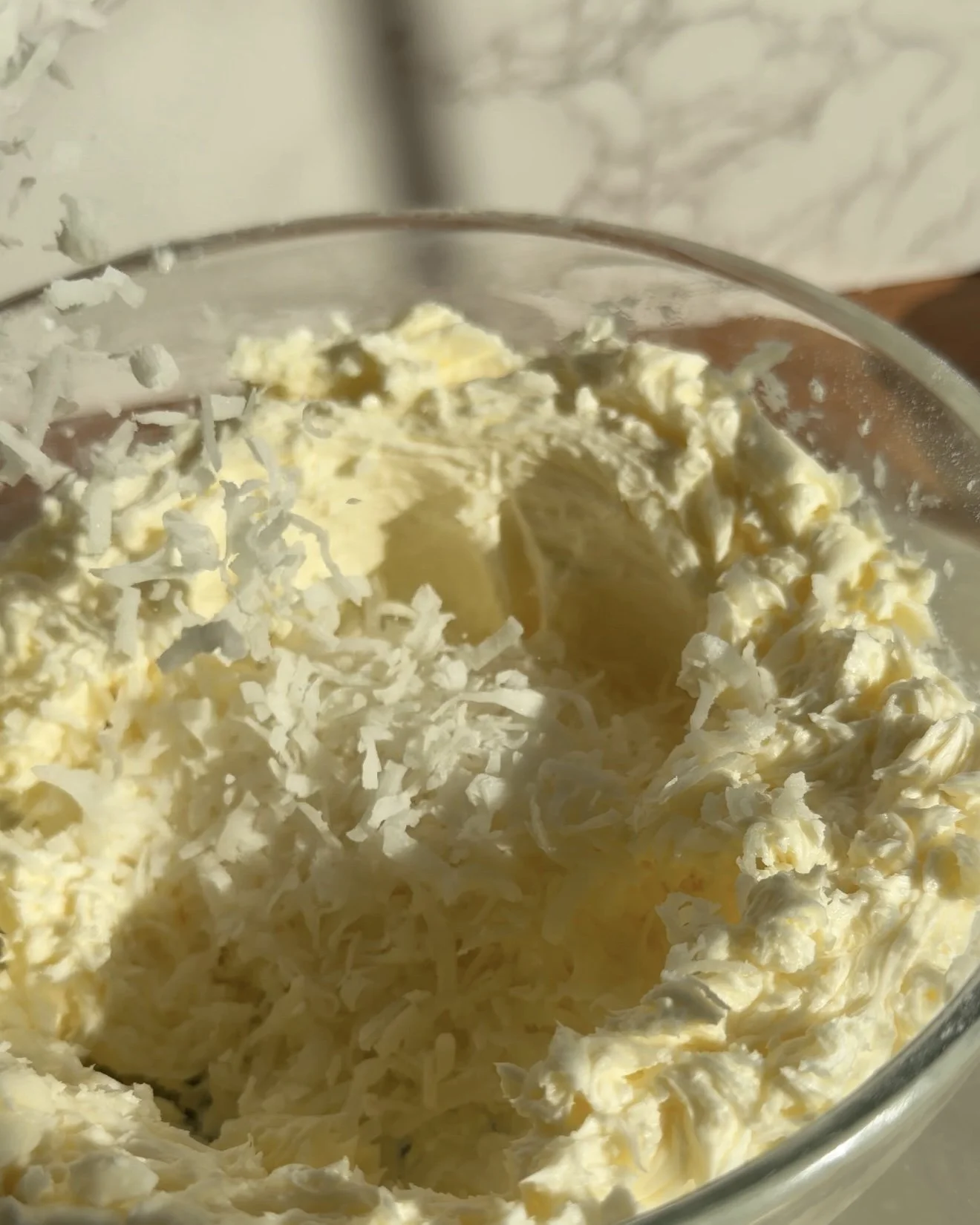 Coconut flakes for frosting in a mixing bowl
