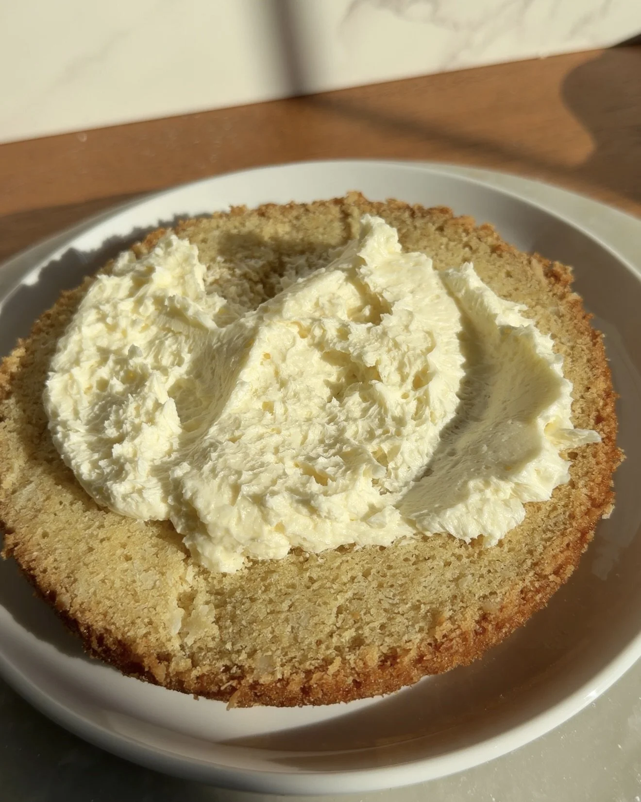 First layer of cake with frosting on the counter