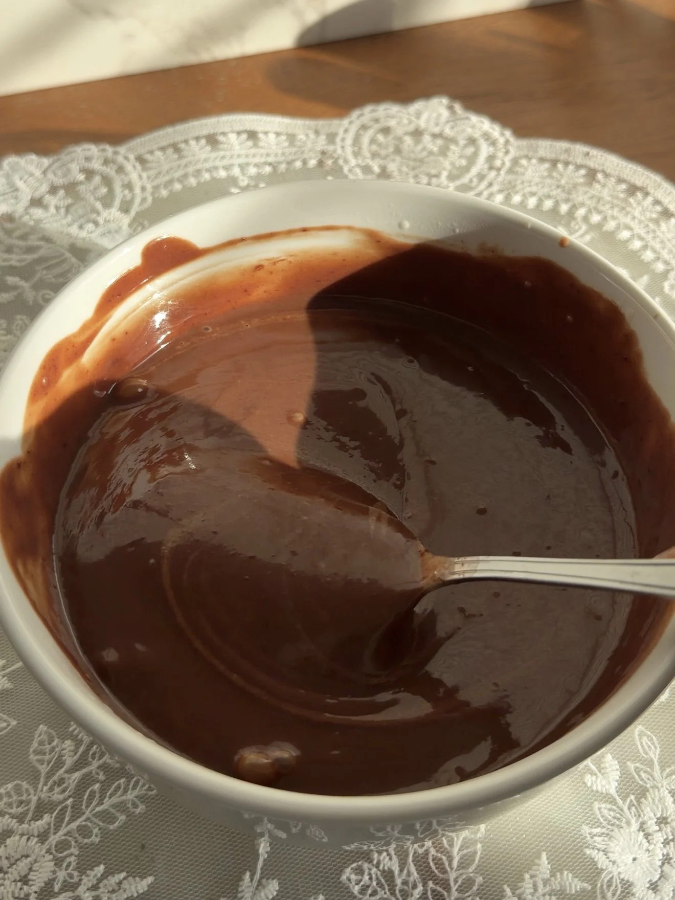 Chocolate ganache in small white mixing bowl.
