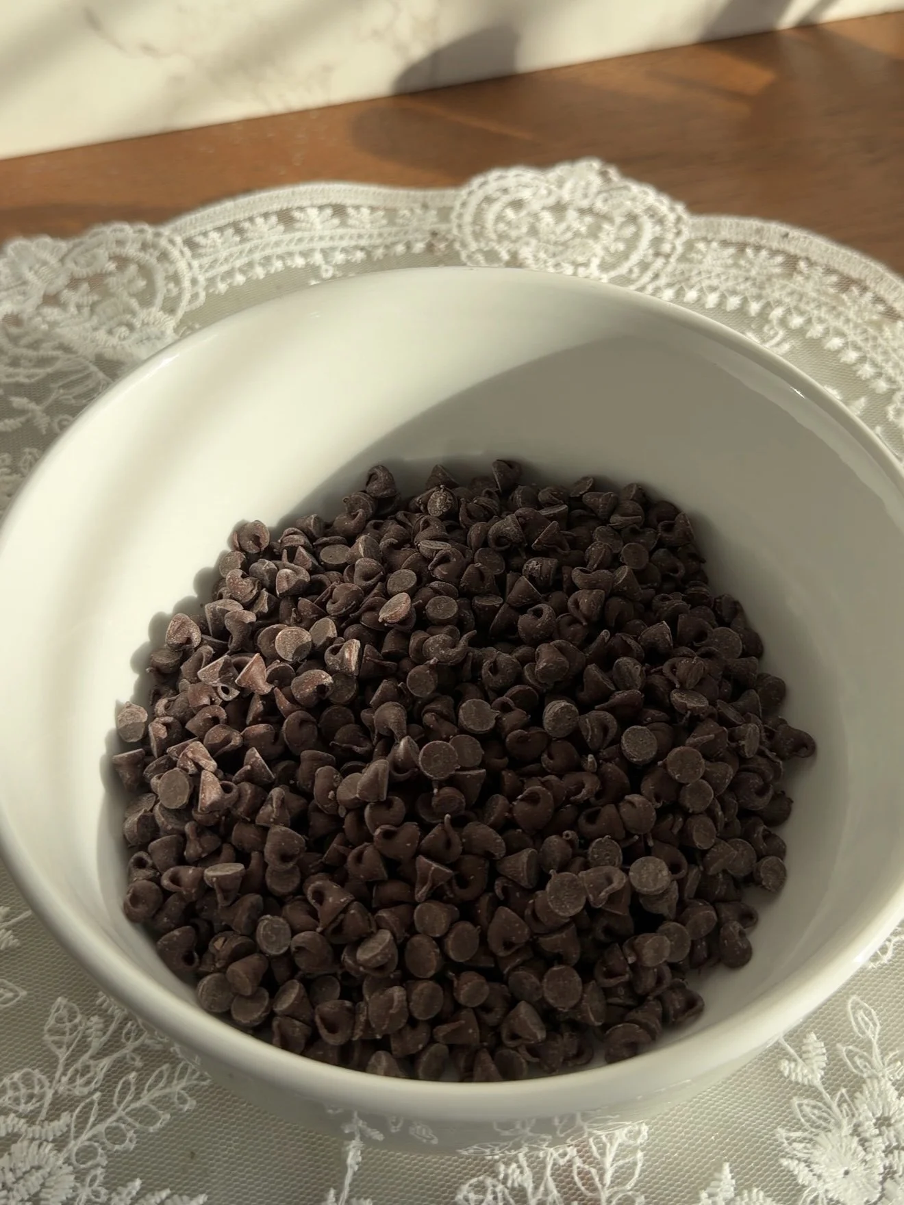 Small white mixing bowl with chocolate chips