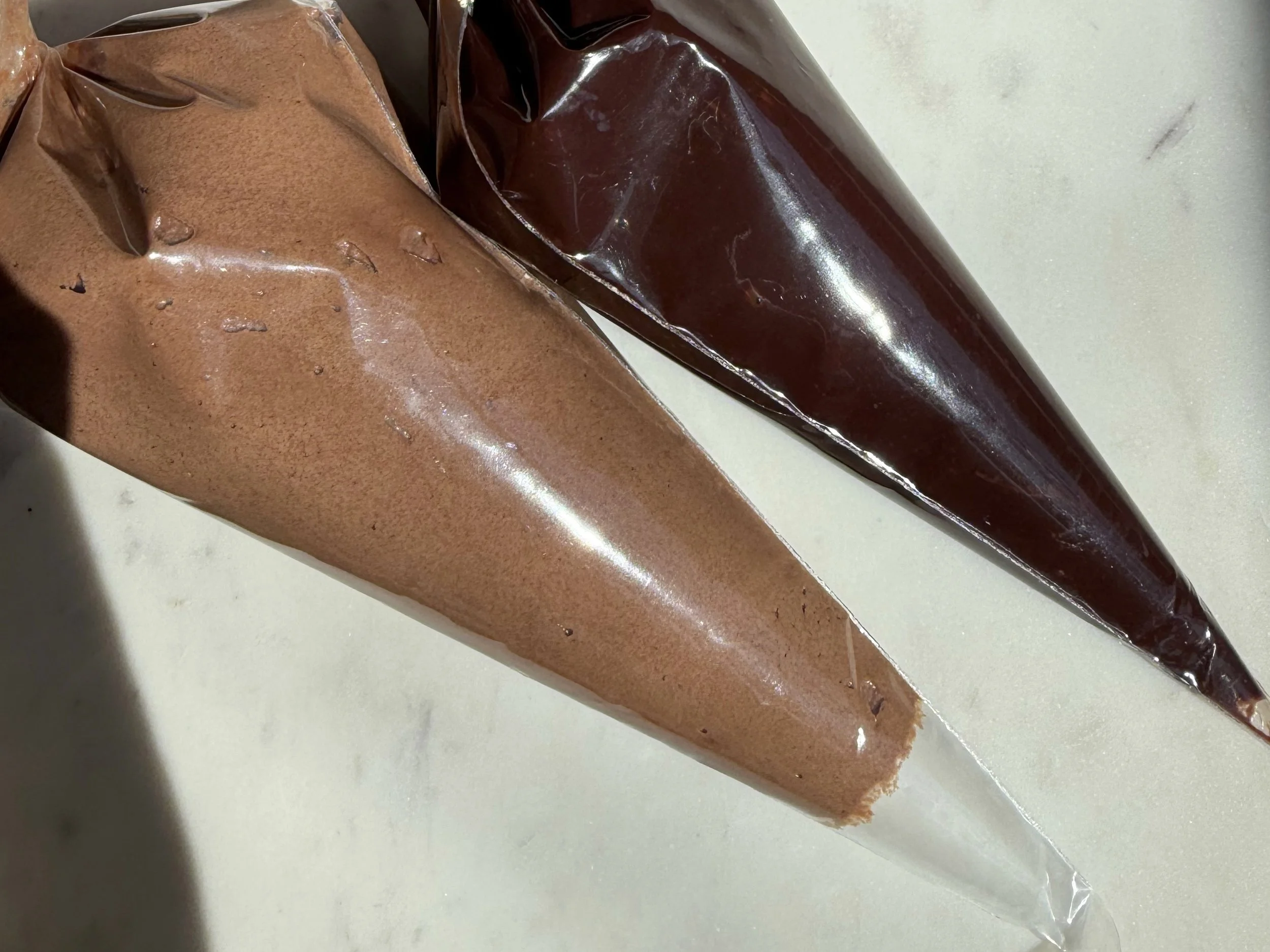 Two piping bags on the counter. 