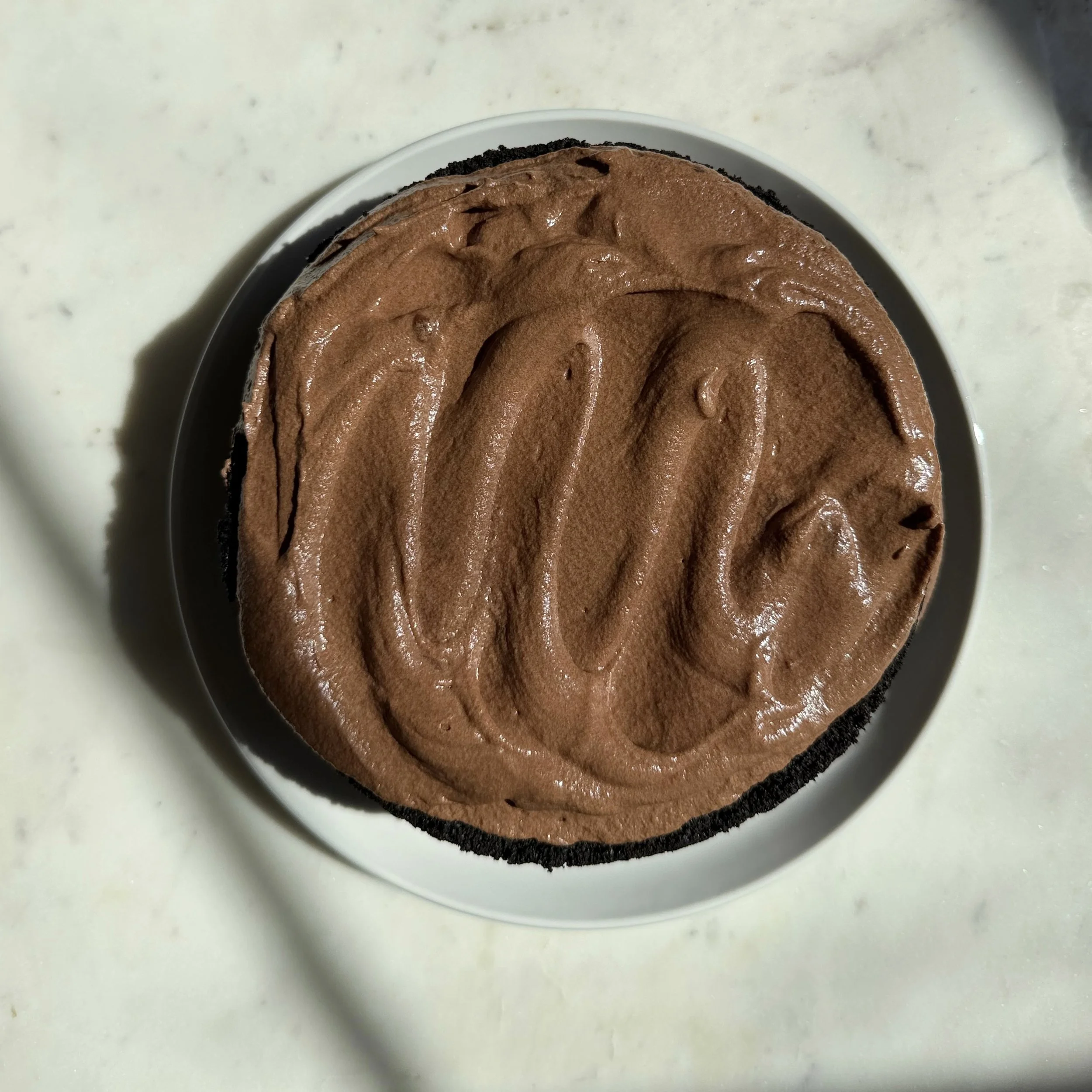 Finished frosted chocolate layered cake.