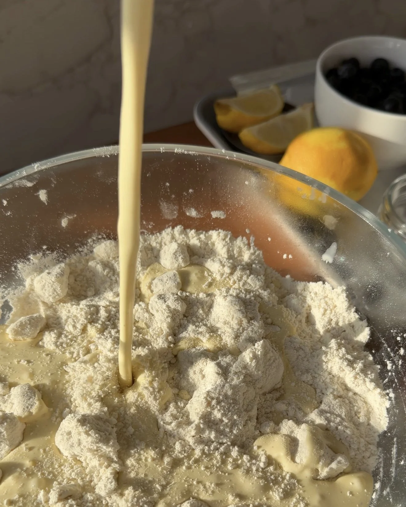Wet ingredients being poured into flour mixture. 