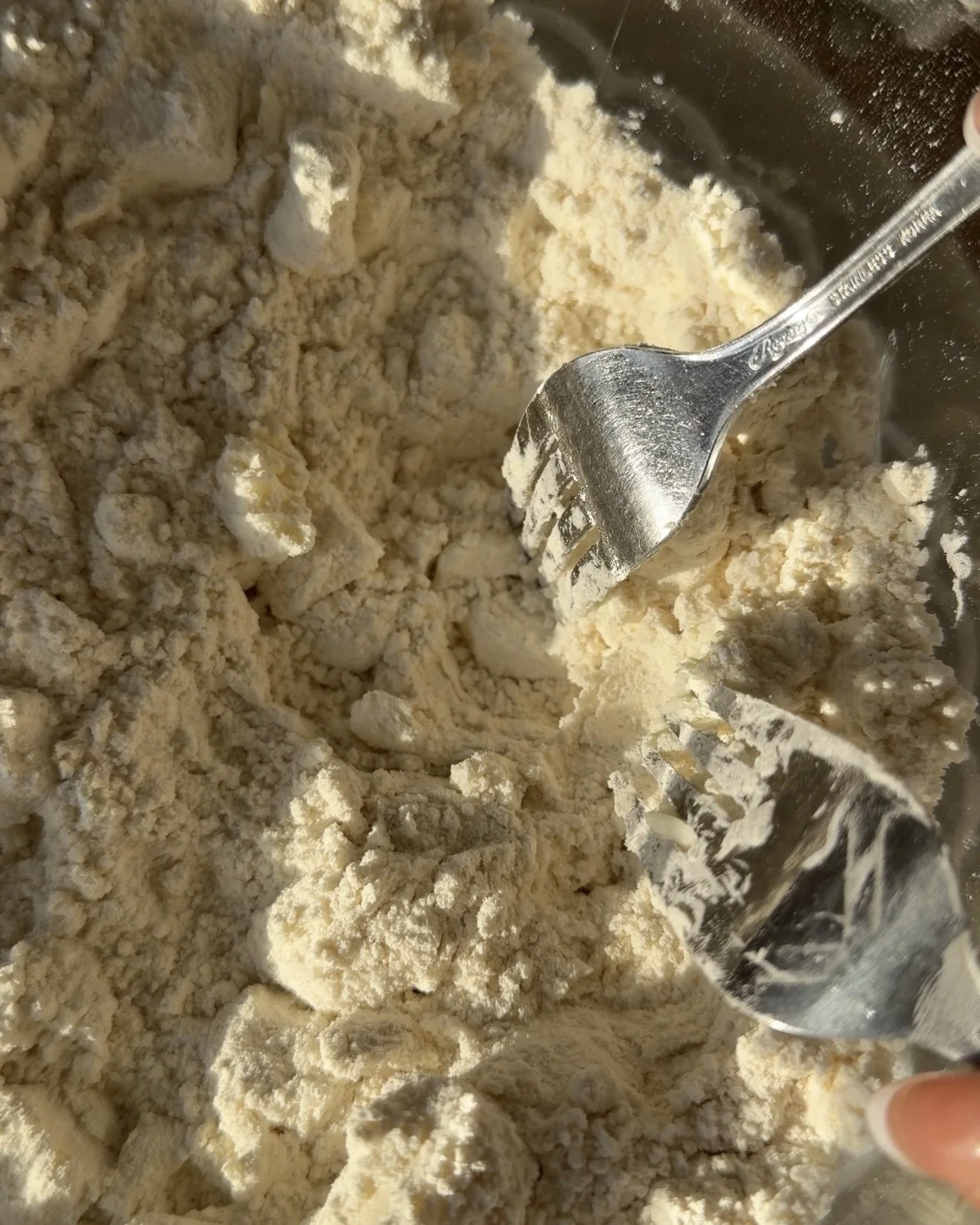 Flour and butter mixture in glass mixing bowl. 