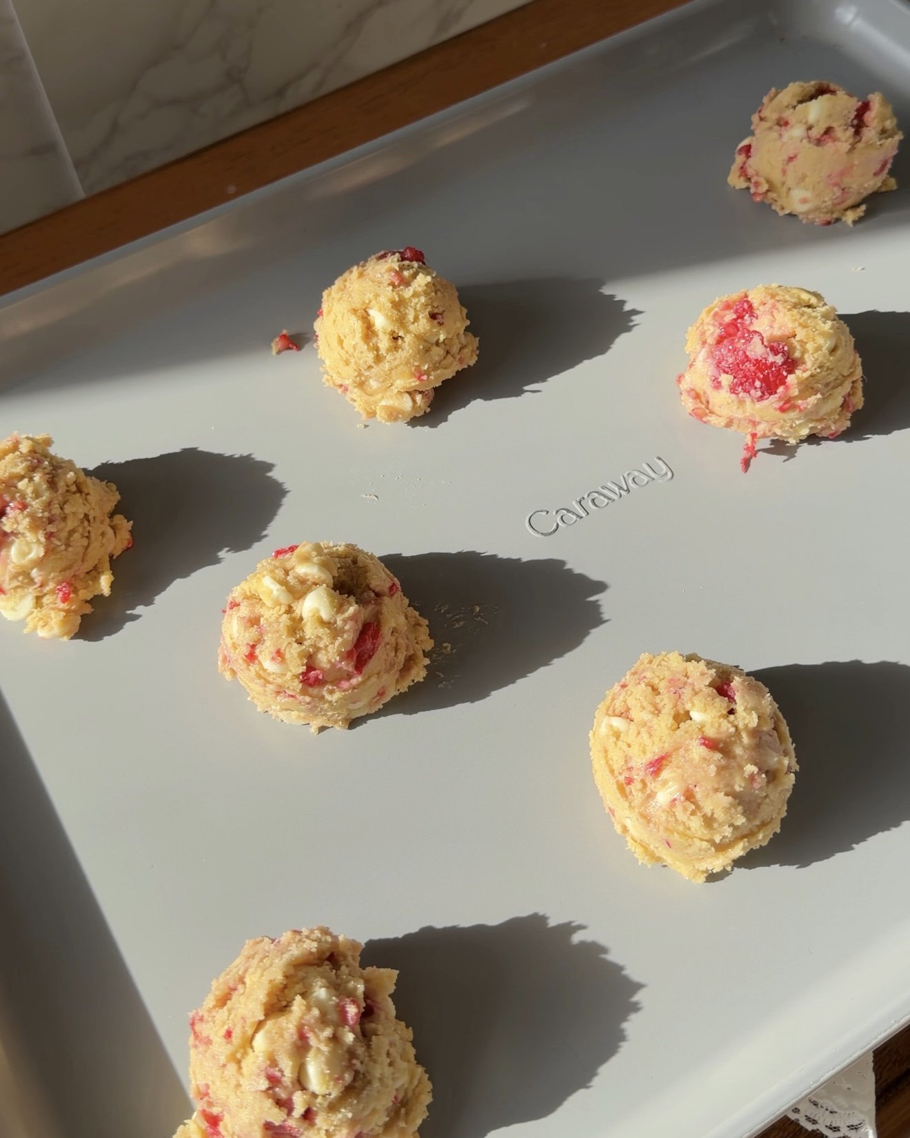 Two tablespoon scoops of cookie dough on baking sheet. 