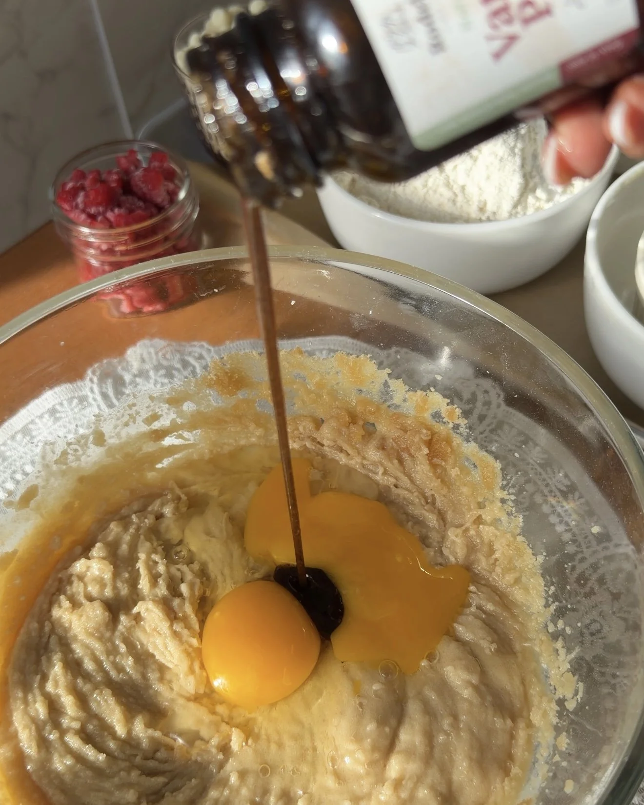 Egg and vanilla bean paste added to wet ingredients.