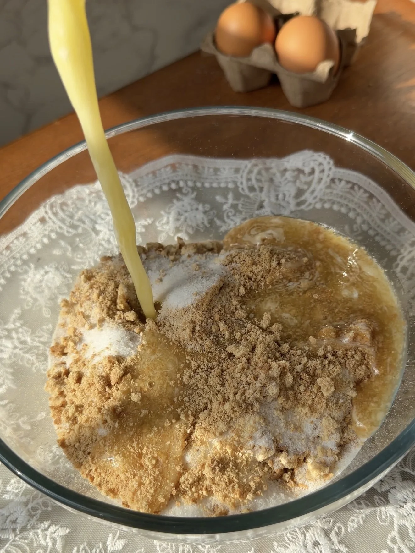 Add melted butter to the graham crackers